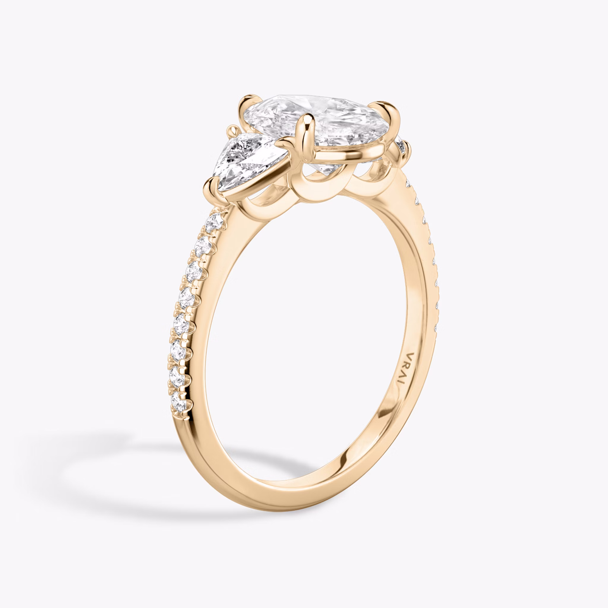 The Three Stone | Pear | 14k | Rose Gold | bandAccent: Pavé | sideStoneCarat: 0.25ct | sideStoneShape: Trillion | diamondOrientation: vertical | caratWeight: other