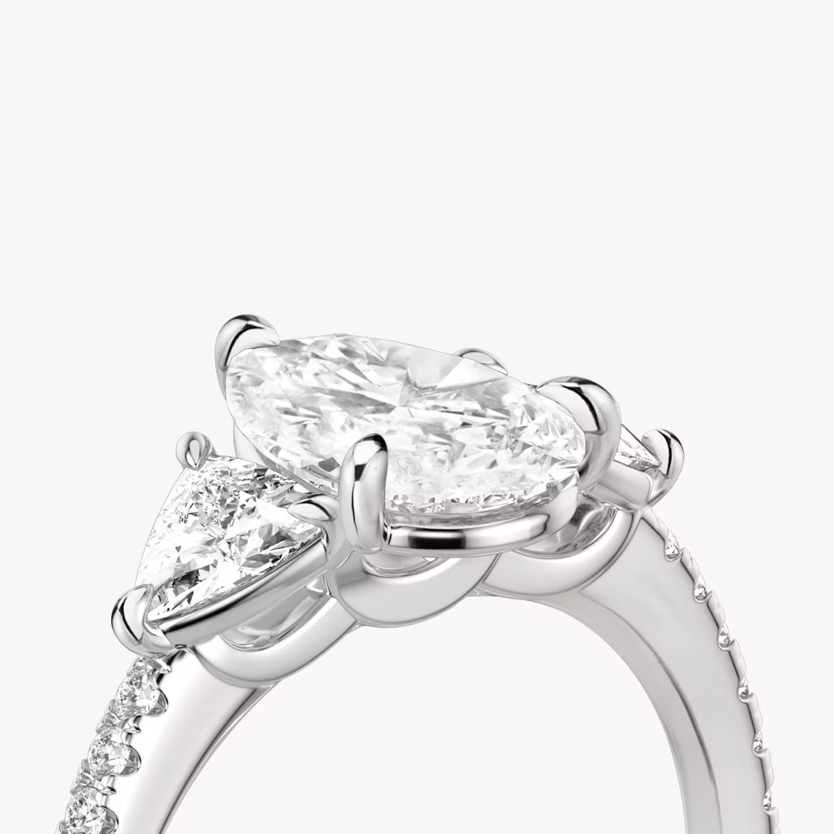 The Three Stone | Pear | Platinum | bandAccent: Pavé | sideStoneCarat: 0.25ct | sideStoneShape: Trillion | diamondOrientation: vertical | caratWeight: other
