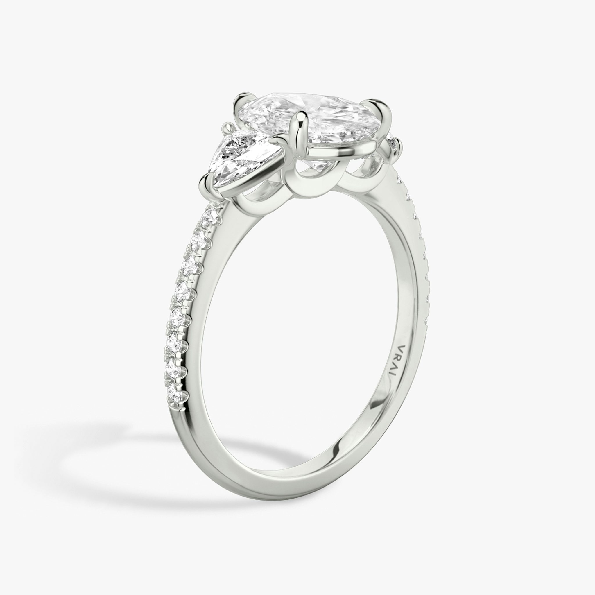 The Three Stone | Pear | Platinum | bandAccent: Pavé | sideStoneCarat: 0.25ct | sideStoneShape: Trillion | diamondOrientation: vertical | caratWeight: other