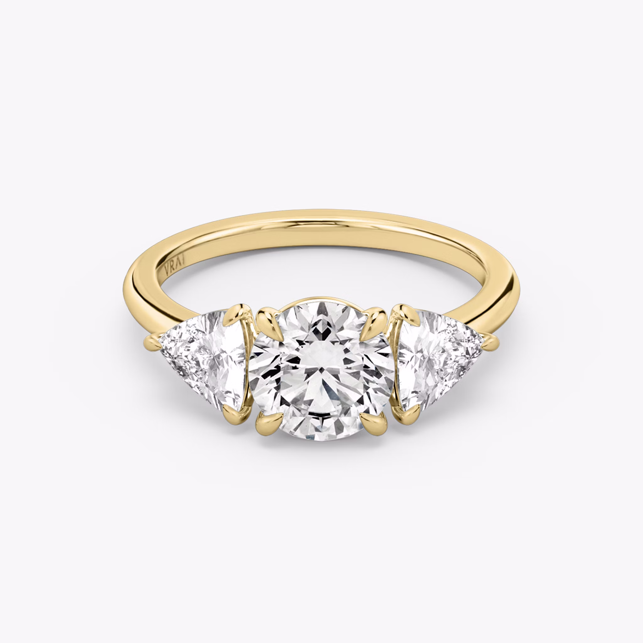 The Three Stone | Round Brilliant | 18k | Yellow Gold | bandAccent: Plain | caratWeight: other | sideStoneCarat: 0.50ct | sideStoneShape: Trillion | diamondOrientation: vertical