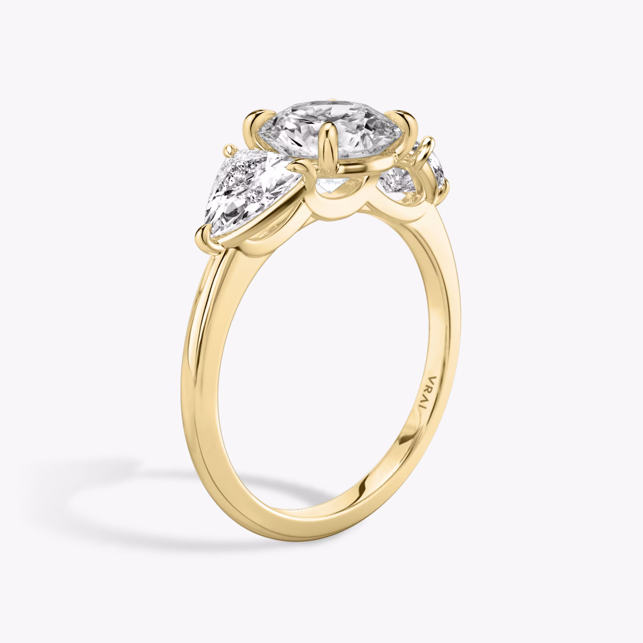 The Three Stone | Round Brilliant | 18k | Yellow Gold | bandAccent: Plain | caratWeight: other | sideStoneCarat: 0.50ct | sideStoneShape: Trillion | diamondOrientation: vertical