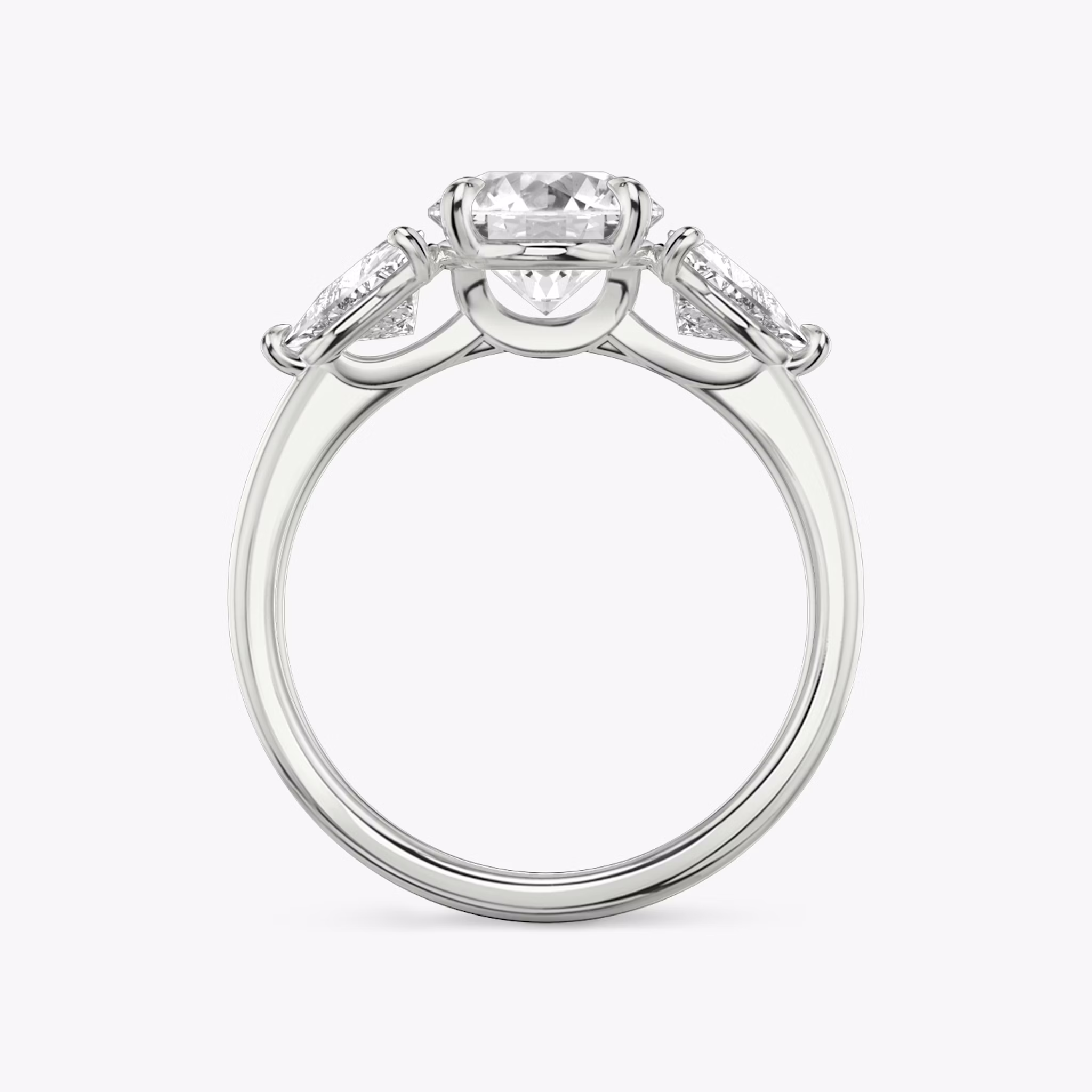 The Three Stone | Round Brilliant | 18k | White Gold | bandAccent: Plain | caratWeight: other | sideStoneCarat: 0.50ct | sideStoneShape: Trillion | diamondOrientation: vertical