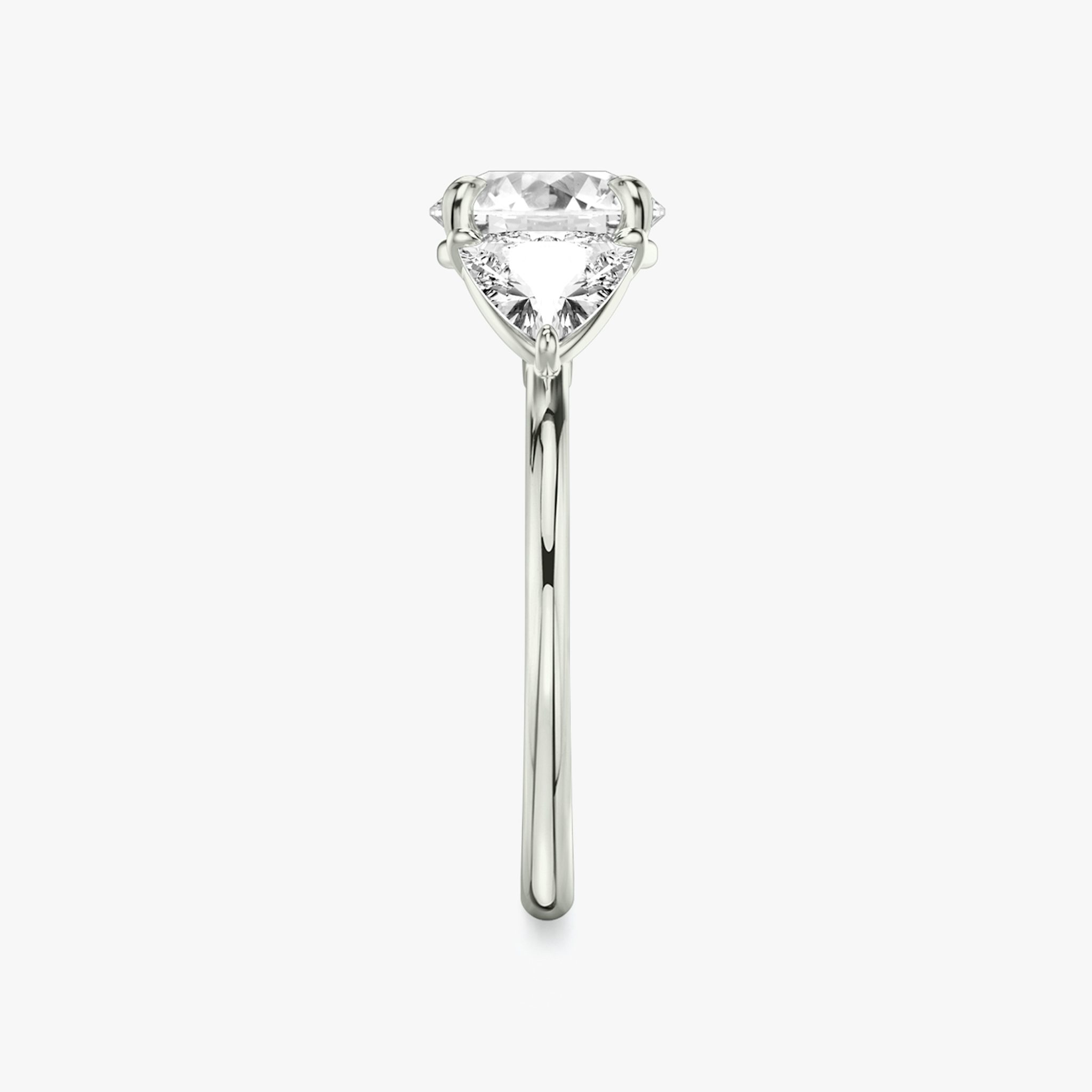The Three Stone | Round Brilliant | 18k | White Gold | bandAccent: Plain | caratWeight: other | sideStoneCarat: 0.50ct | sideStoneShape: Trillion | diamondOrientation: vertical
