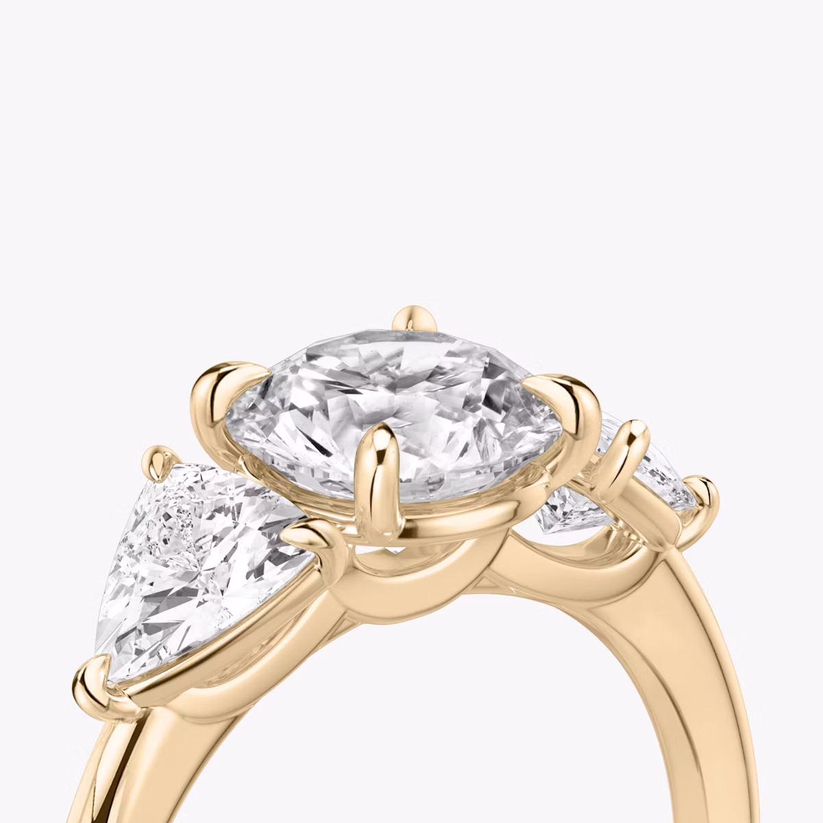 The Three Stone | Round Brilliant | 14k | Rose Gold | bandAccent: Plain | caratWeight: other | sideStoneCarat: 0.50ct | sideStoneShape: Trillion | diamondOrientation: vertical