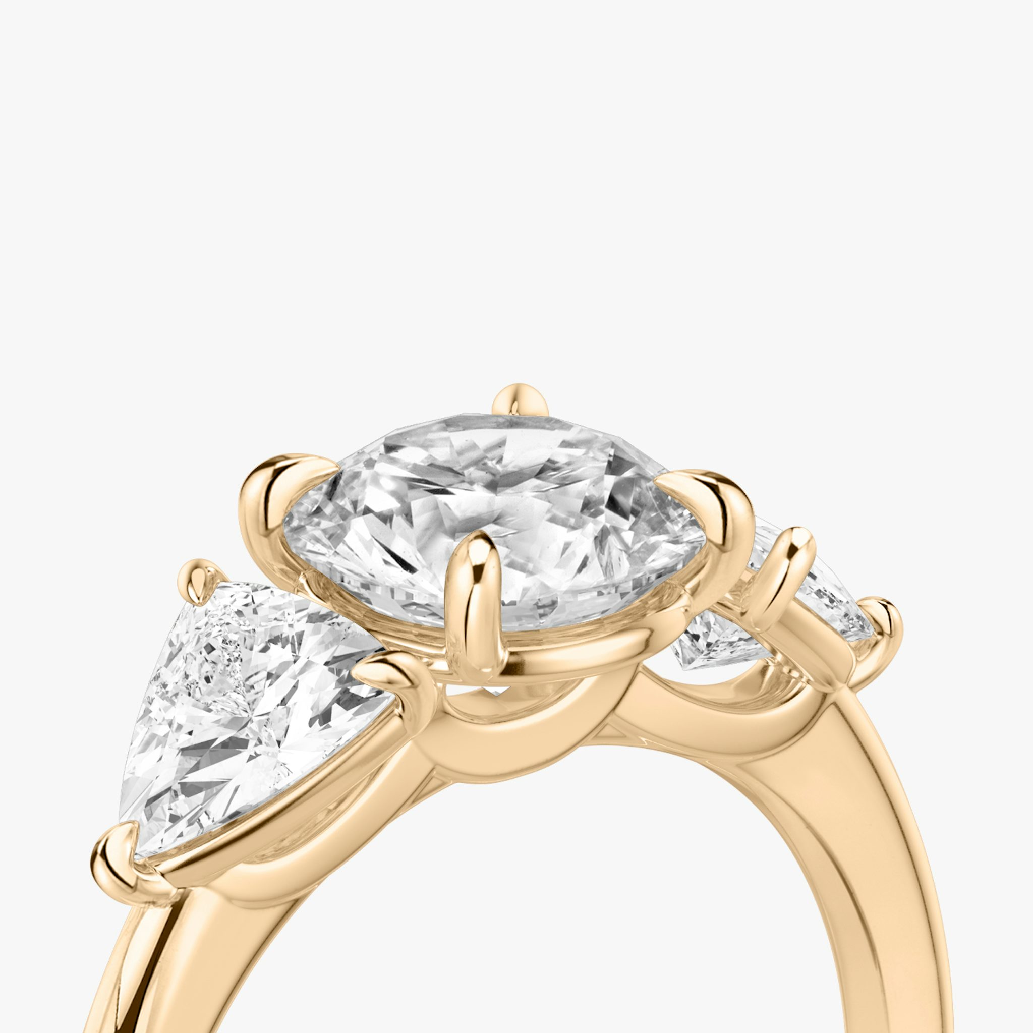The Three Stone | Round Brilliant | 14k | Rose Gold | bandAccent: Plain | caratWeight: other | sideStoneCarat: 0.50ct | sideStoneShape: Trillion | diamondOrientation: vertical