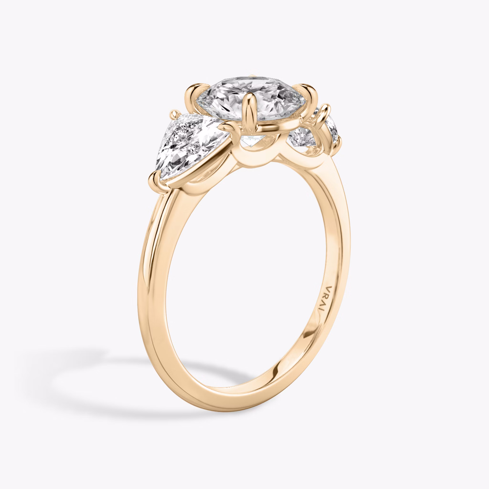 The Three Stone | Round Brilliant | 14k | Rose Gold | bandAccent: Plain | caratWeight: other | sideStoneCarat: 0.50ct | sideStoneShape: Trillion | diamondOrientation: vertical