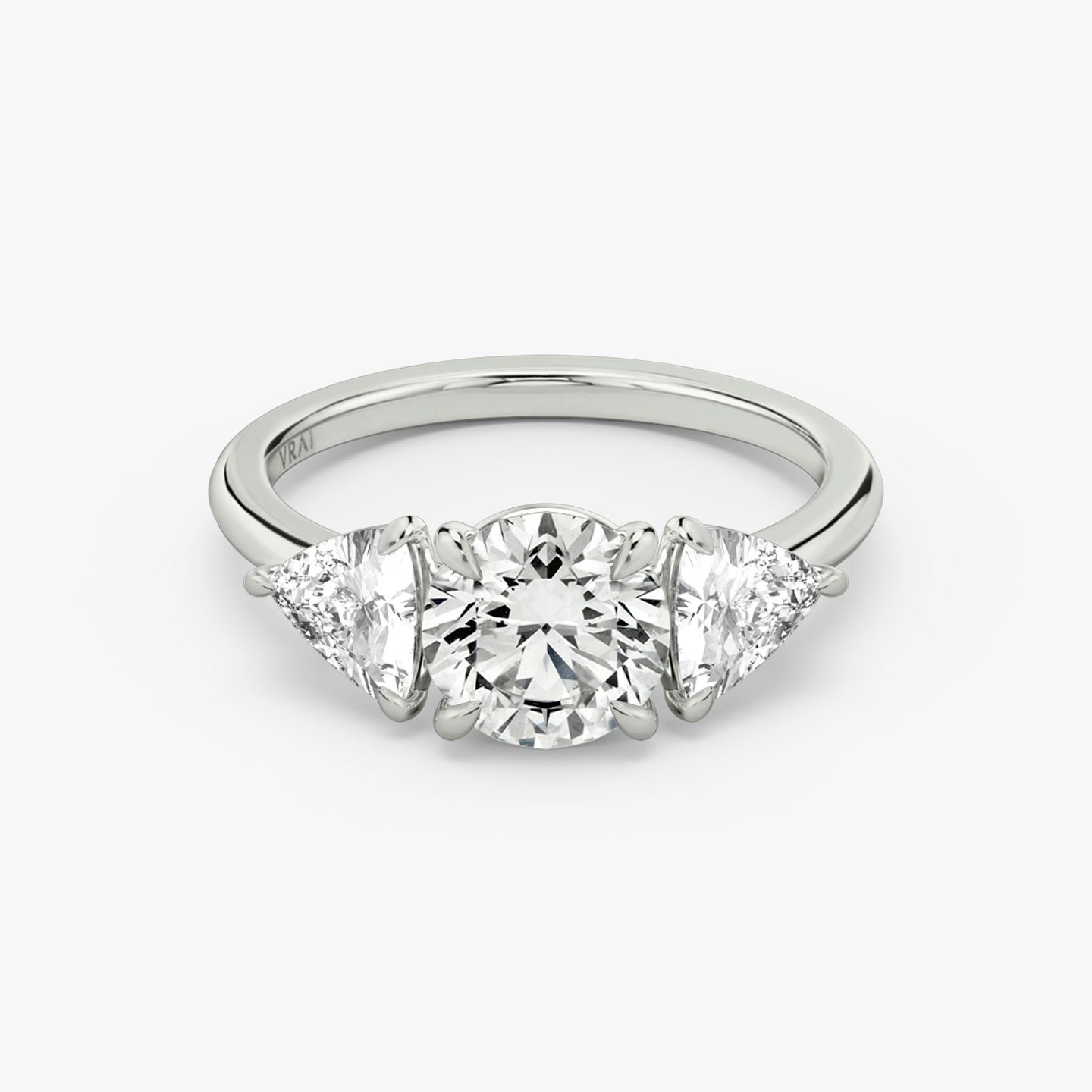 The Three Stone | Round Brilliant | Platinum | bandAccent: Plain | caratWeight: other | sideStoneCarat: 0.50ct | sideStoneShape: Trillion | diamondOrientation: vertical