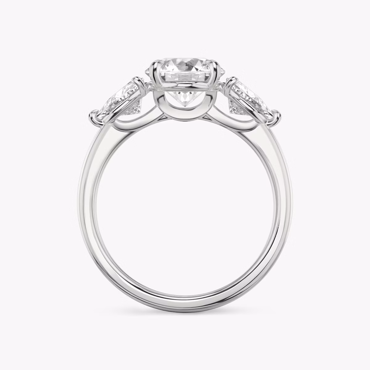 The Three Stone | Round Brilliant | Platinum | bandAccent: Plain | caratWeight: other | sideStoneCarat: 0.50ct | sideStoneShape: Trillion | diamondOrientation: vertical