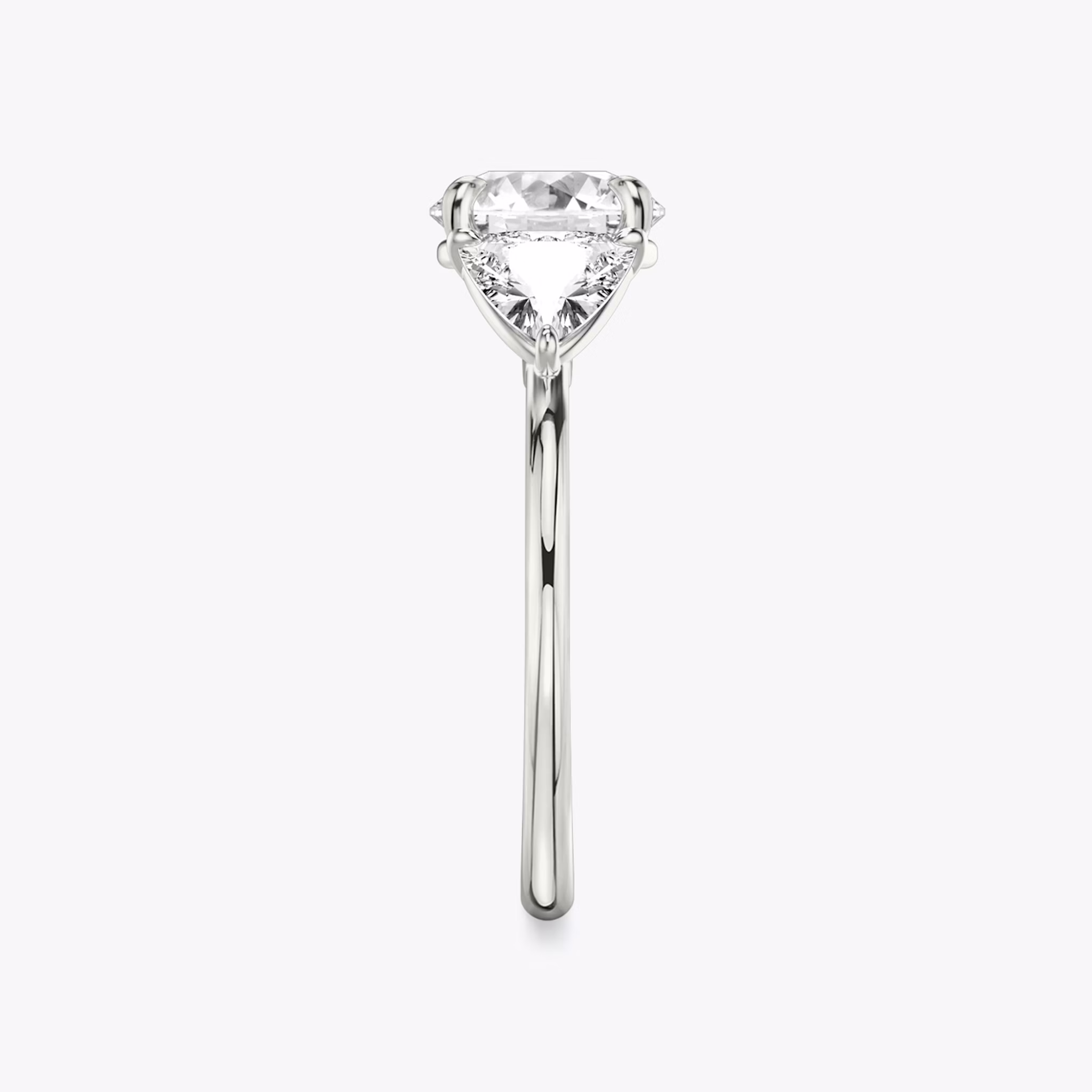 The Three Stone | Round Brilliant | Platinum | bandAccent: Plain | caratWeight: other | sideStoneCarat: 0.50ct | sideStoneShape: Trillion | diamondOrientation: vertical