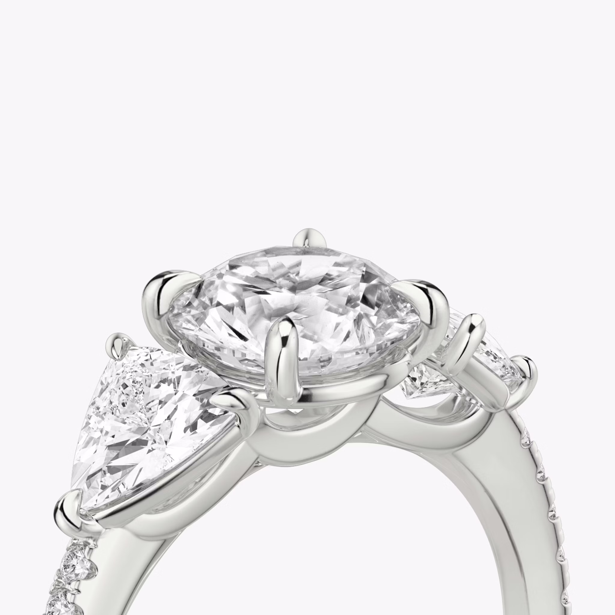 The Three Stone | Round Brilliant | 18k | White Gold | bandAccent: Pavé | caratWeight: other | sideStoneCarat: 0.50ct | sideStoneShape: Trillion | diamondOrientation: vertical
