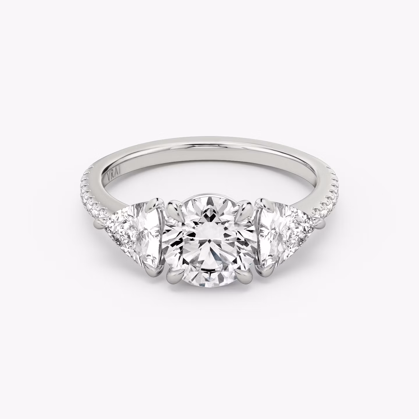 The Three Stone | Round Brilliant | 18k | White Gold | bandAccent: Pavé | caratWeight: other | sideStoneCarat: 0.50ct | sideStoneShape: Trillion | diamondOrientation: vertical