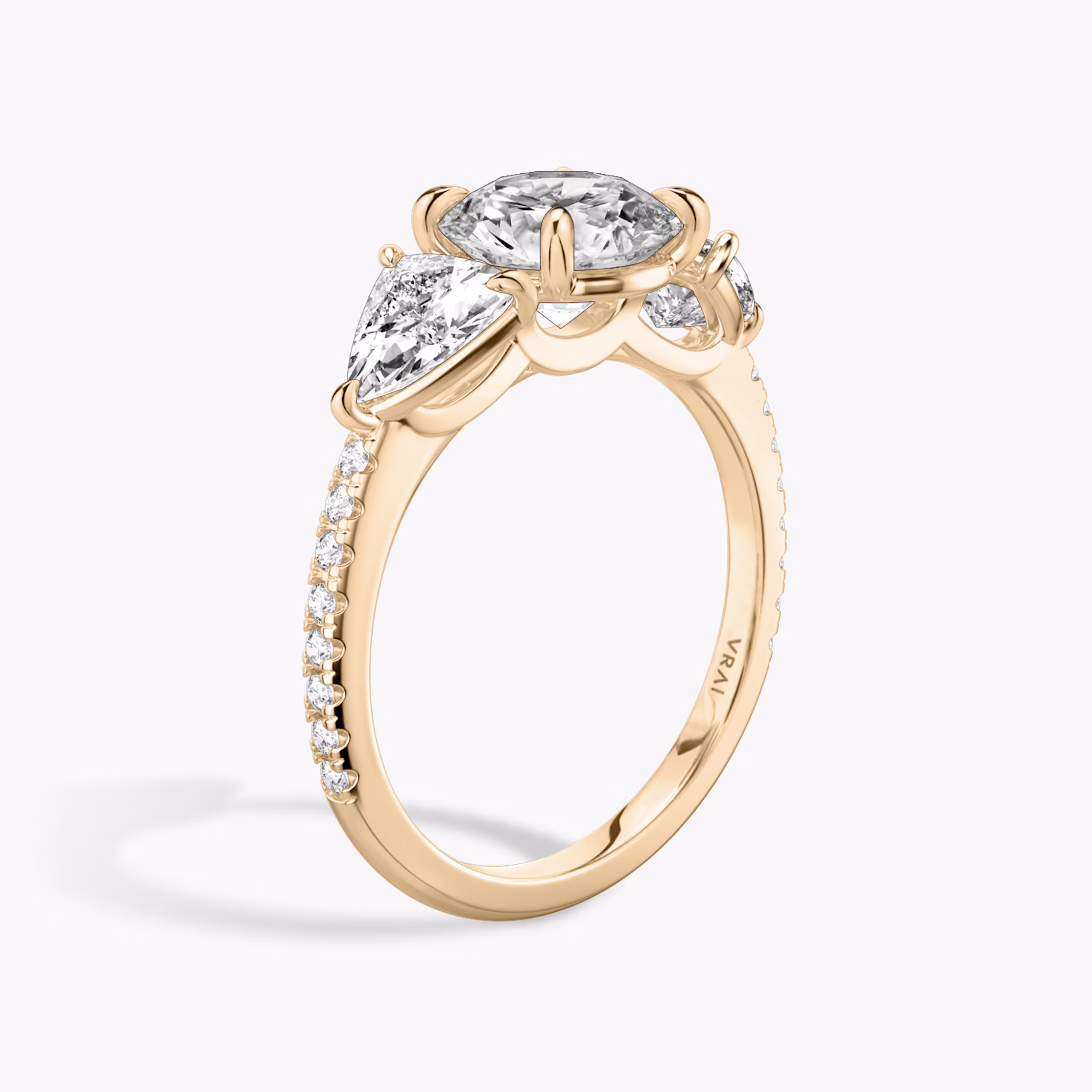 The Three Stone | Round Brilliant | 14k | Rose Gold | bandAccent: Pavé | caratWeight: other | sideStoneCarat: 0.50ct | sideStoneShape: Trillion | diamondOrientation: vertical