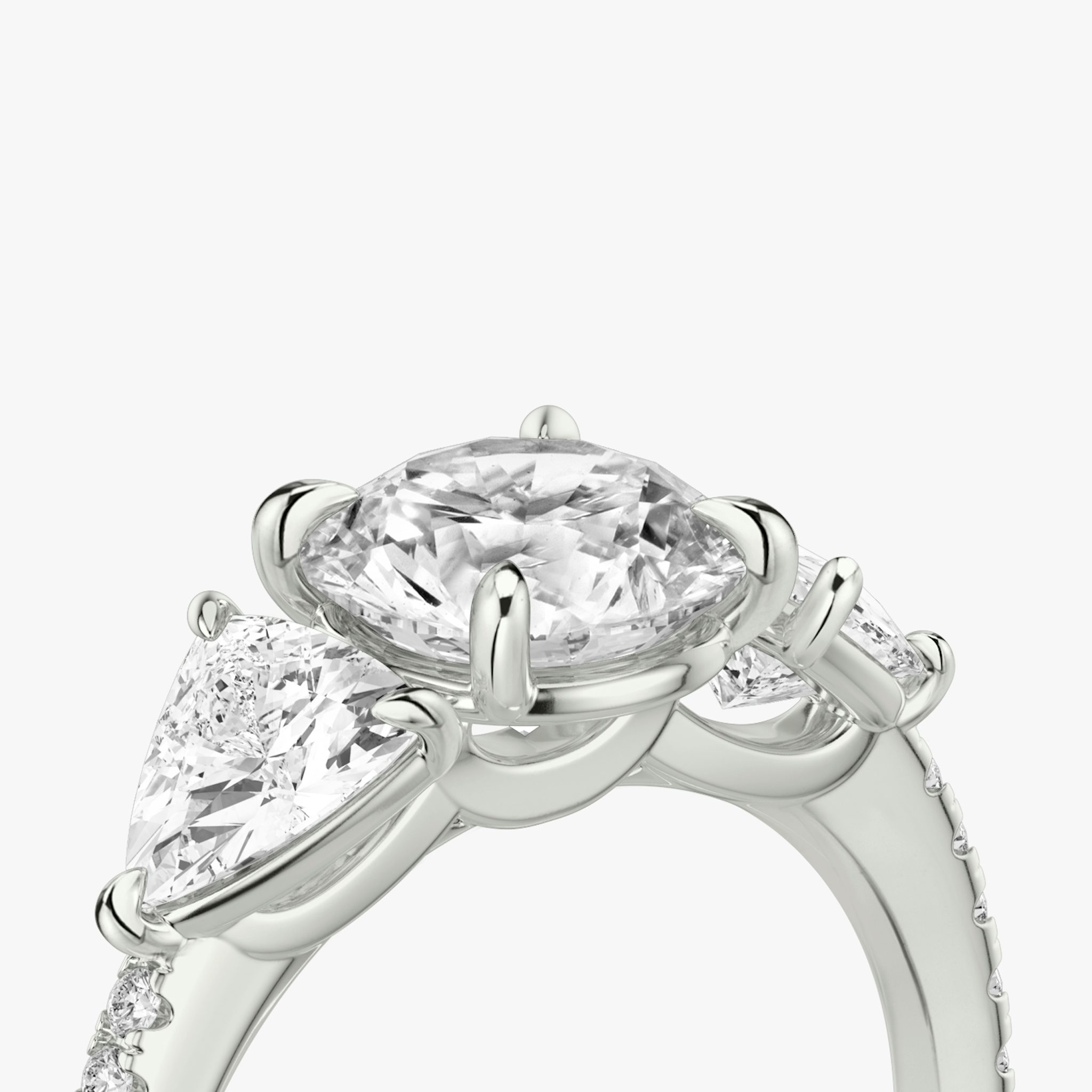 The Three Stone | Round Brilliant | Platinum | bandAccent: Pavé | caratWeight: other | sideStoneCarat: 0.50ct | sideStoneShape: Trillion | diamondOrientation: vertical