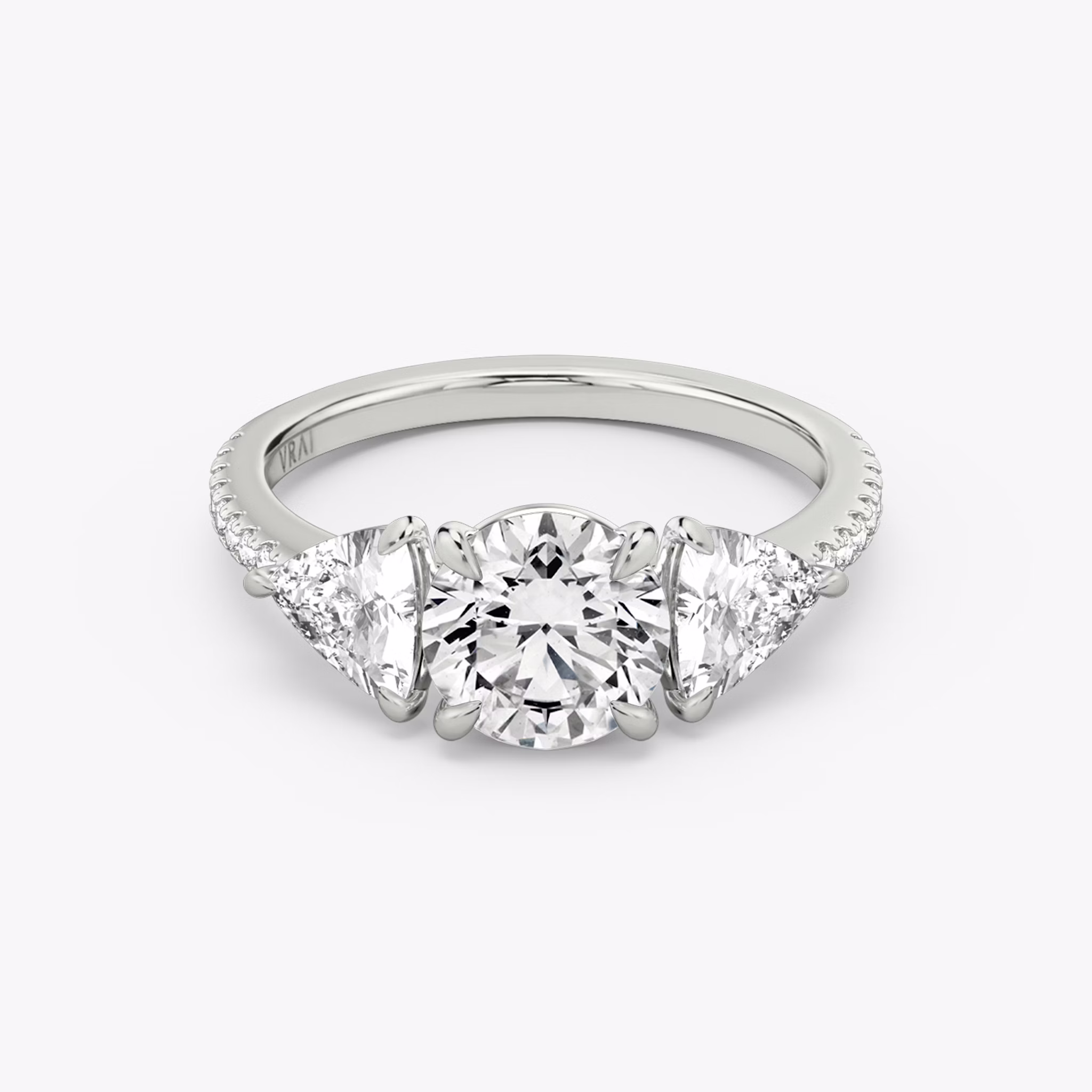 The Three Stone | Round Brilliant | Platinum | bandAccent: Pavé | caratWeight: other | sideStoneCarat: 0.50ct | sideStoneShape: Trillion | diamondOrientation: vertical