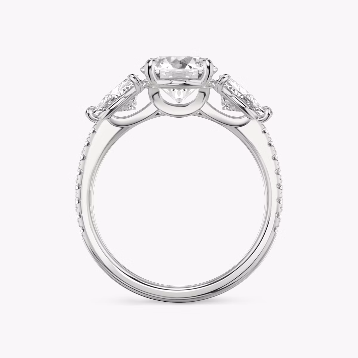 The Three Stone | Round Brilliant | Platinum | bandAccent: Pavé | caratWeight: other | sideStoneCarat: 0.50ct | sideStoneShape: Trillion | diamondOrientation: vertical