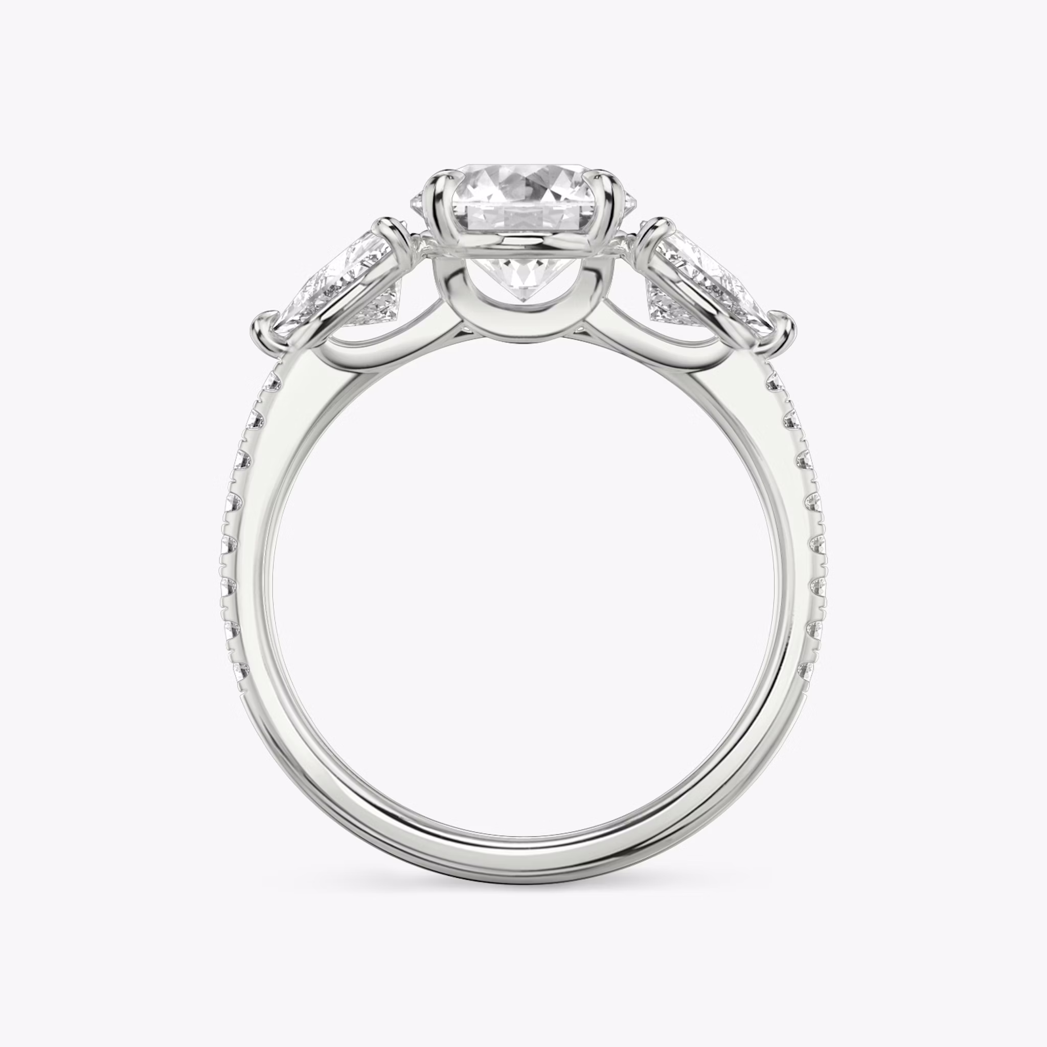 The Three Stone | Round Brilliant | Platinum | bandAccent: Pavé | caratWeight: other | sideStoneCarat: 0.50ct | sideStoneShape: Trillion | diamondOrientation: vertical