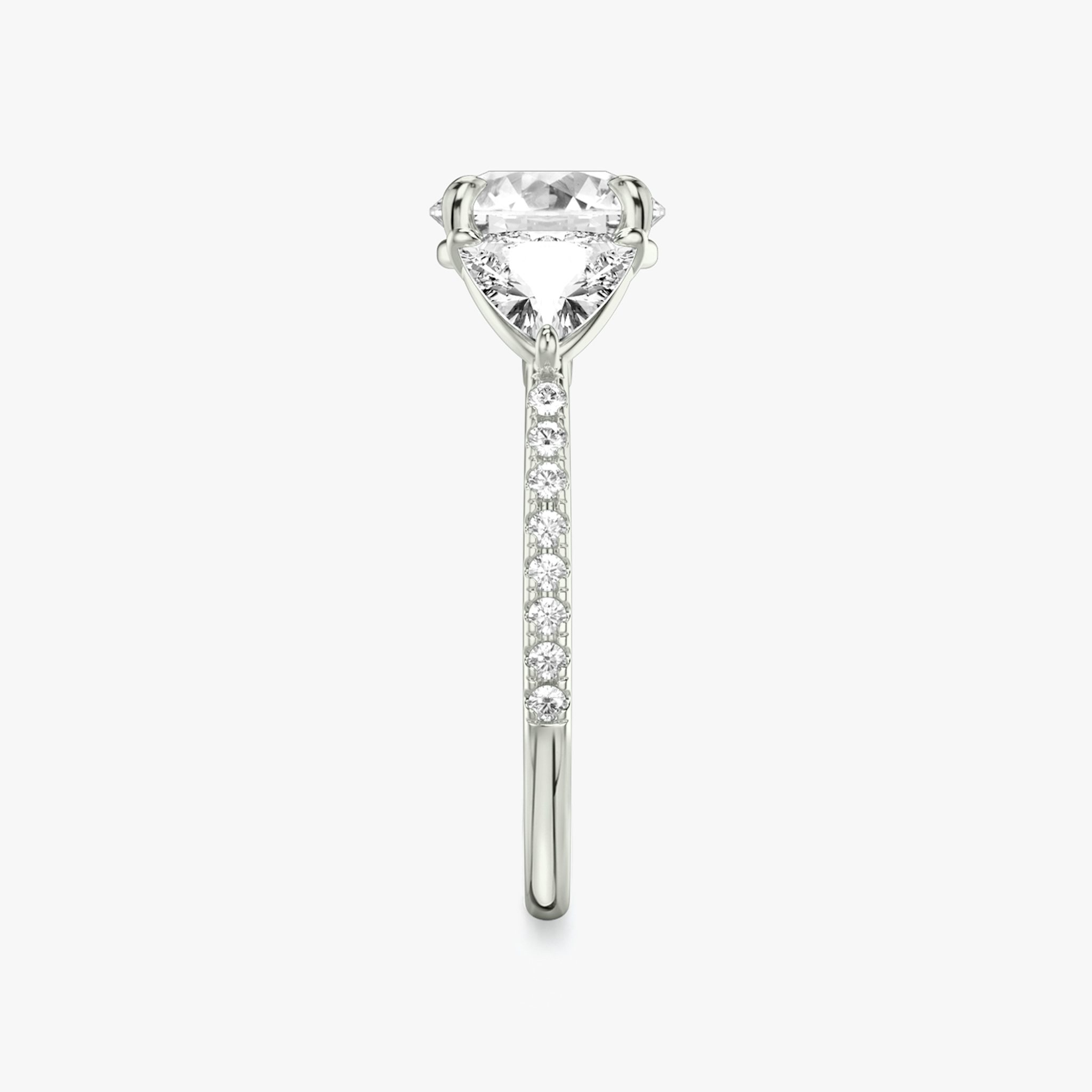 The Three Stone | Round Brilliant | Platinum | bandAccent: Pavé | caratWeight: other | sideStoneCarat: 0.50ct | sideStoneShape: Trillion | diamondOrientation: vertical