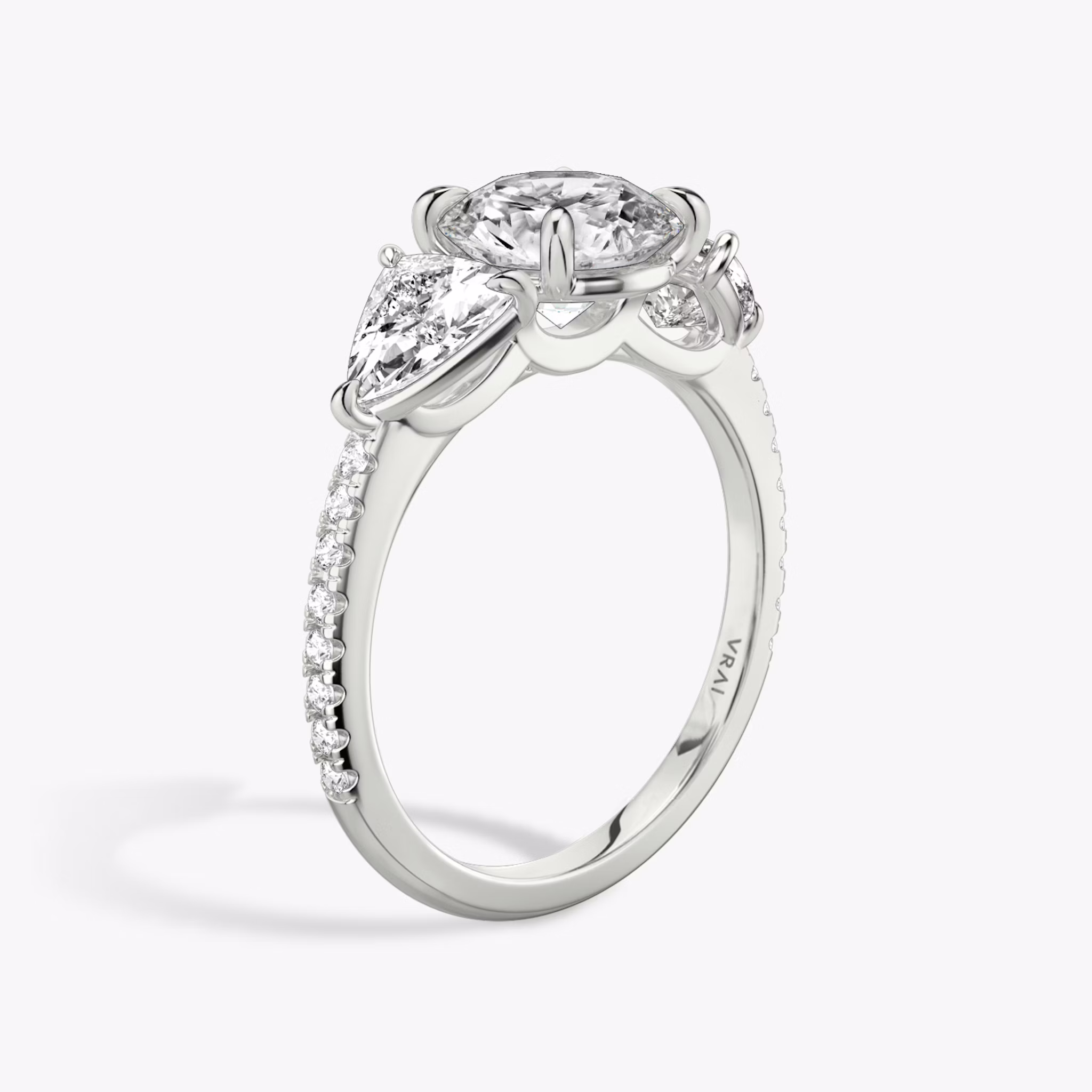 The Three Stone | Round Brilliant | Platinum | bandAccent: Pavé | caratWeight: other | sideStoneCarat: 0.50ct | sideStoneShape: Trillion | diamondOrientation: vertical