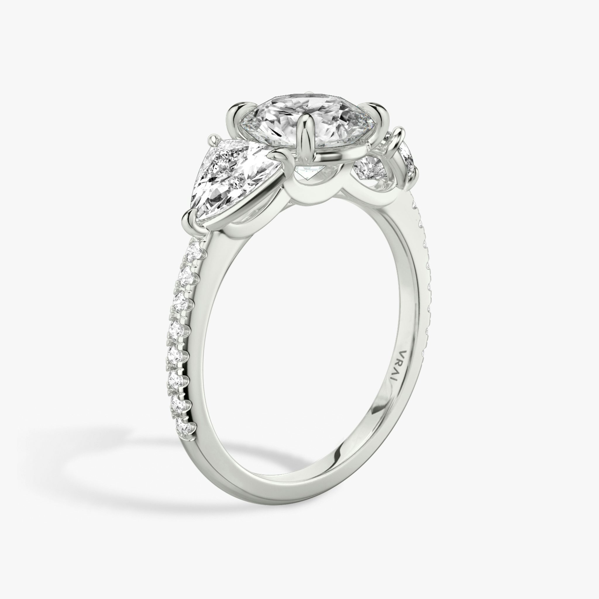 The Three Stone | Round Brilliant | Platinum | bandAccent: Pavé | caratWeight: other | sideStoneCarat: 0.50ct | sideStoneShape: Trillion | diamondOrientation: vertical