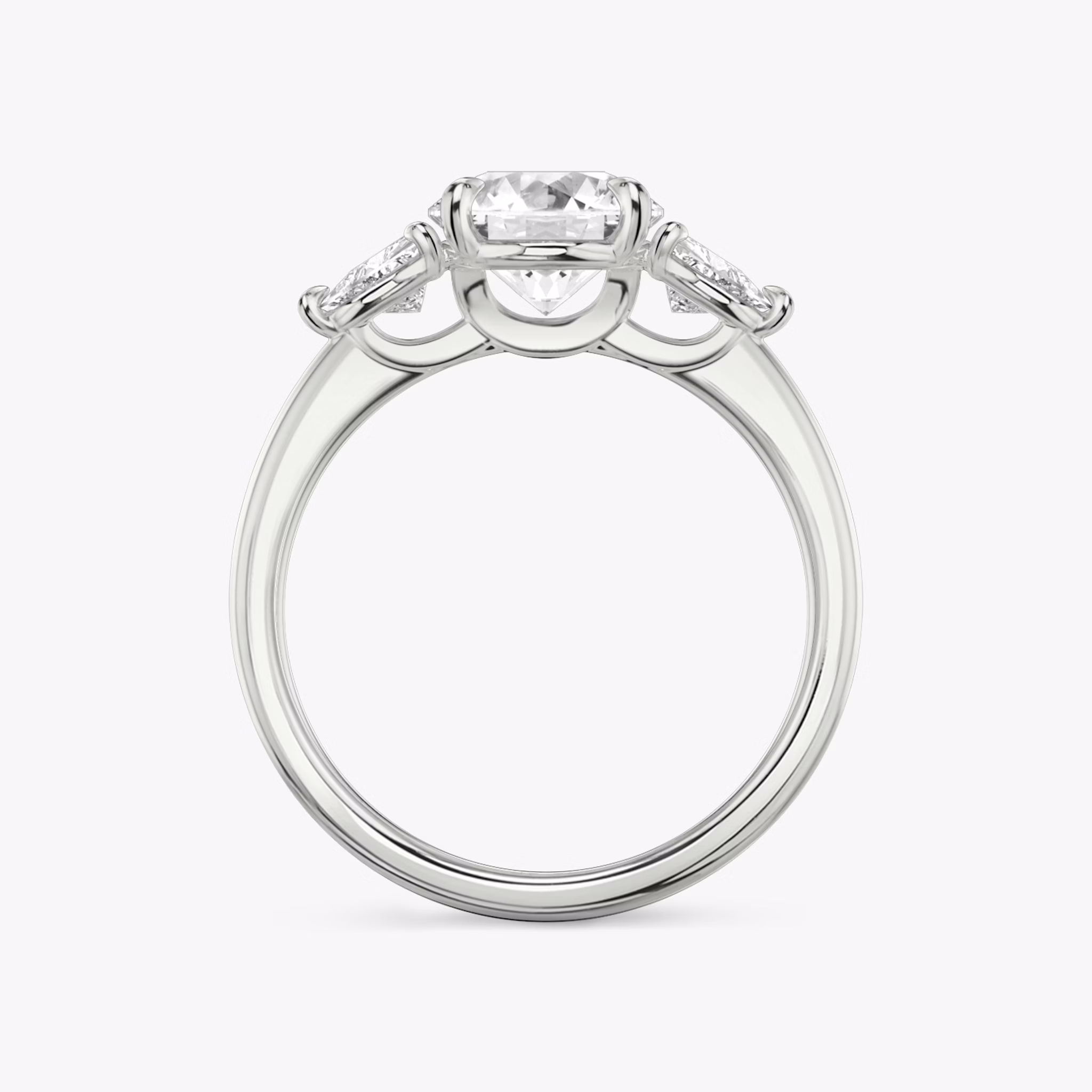 The Three Stone | Round Brilliant | 18k | White Gold | bandAccent: Plain | caratWeight: other | sideStoneCarat: 0.25ct | sideStoneShape: Trillion | diamondOrientation: vertical