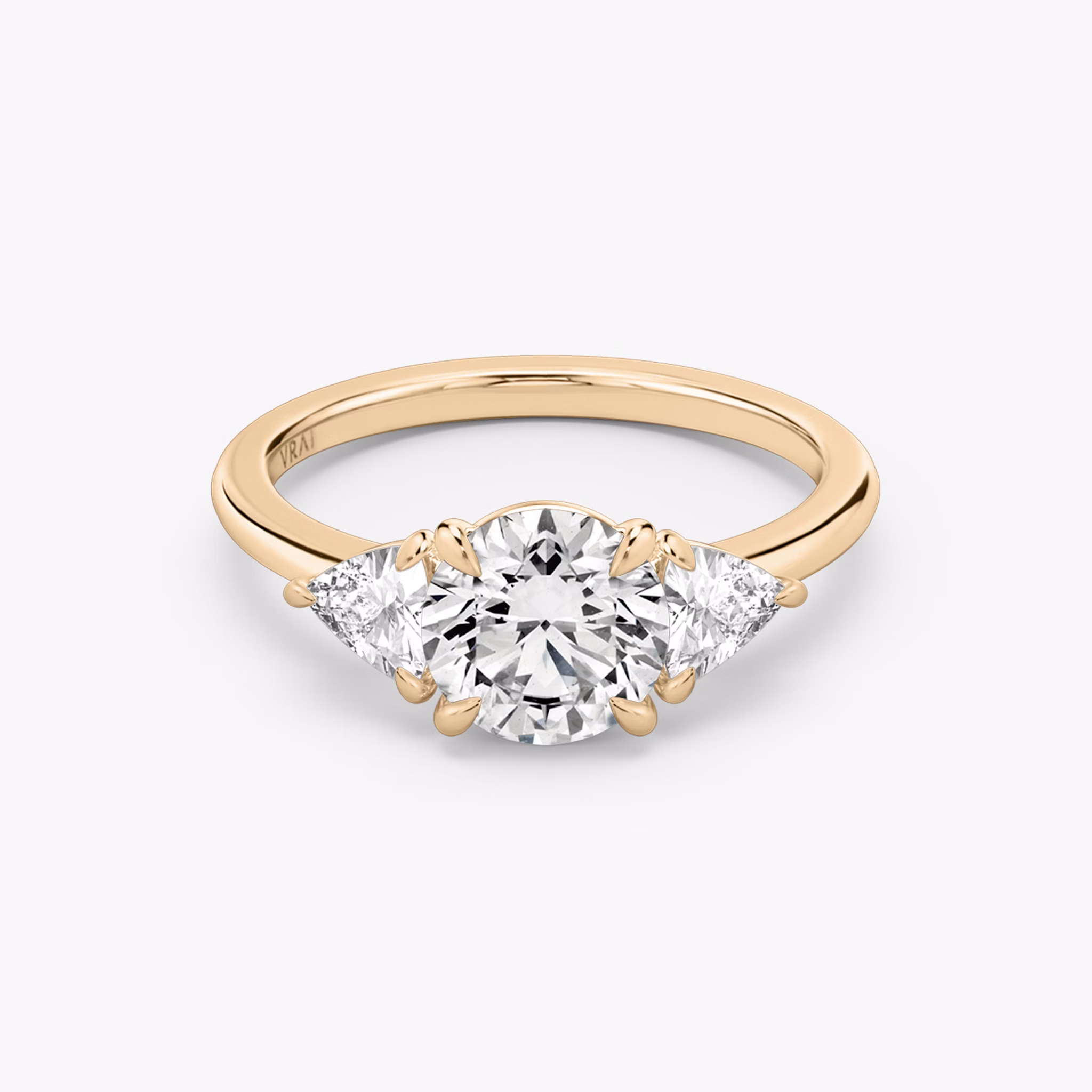 The Three Stone | Round Brilliant | 14k | Rose Gold | bandAccent: Plain | caratWeight: other | sideStoneCarat: 0.25ct | sideStoneShape: Trillion | diamondOrientation: vertical
