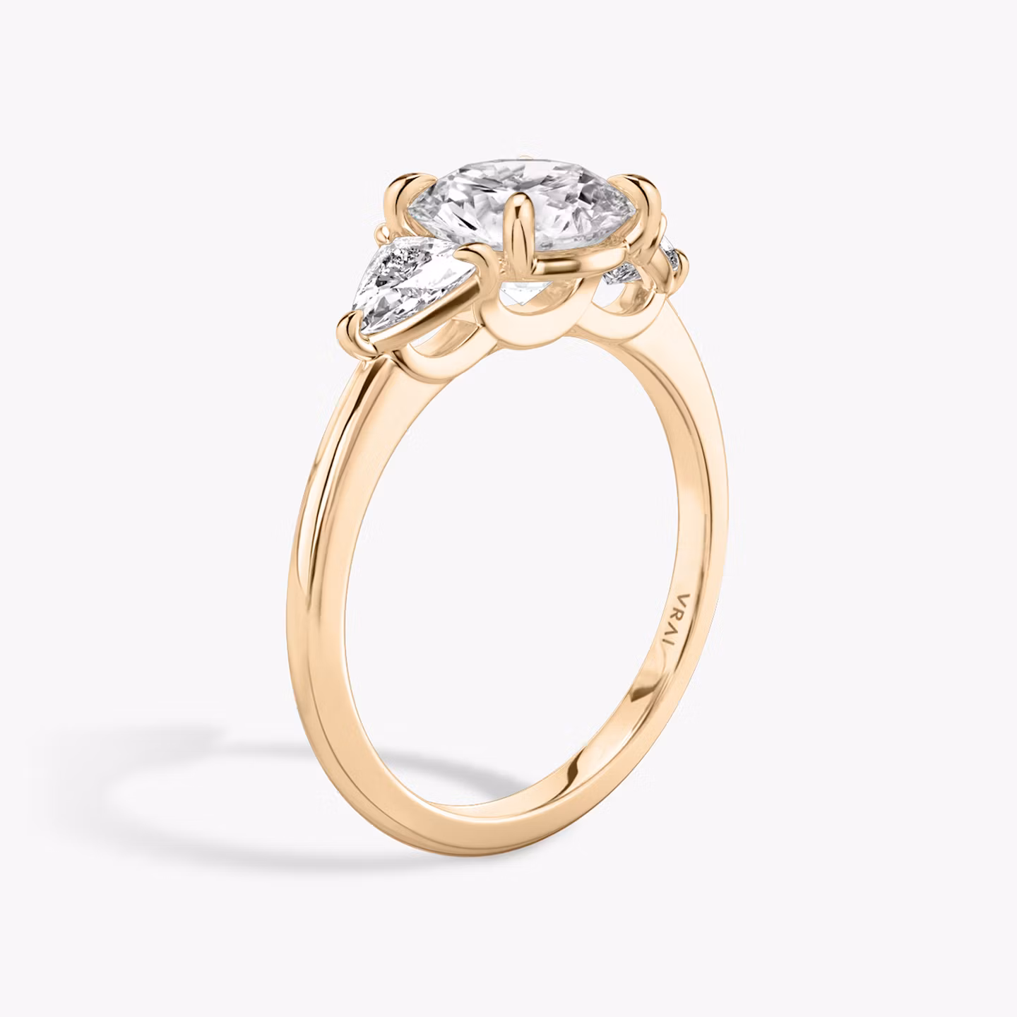 The Three Stone | Round Brilliant | 14k | Rose Gold | bandAccent: Plain | caratWeight: other | sideStoneCarat: 0.25ct | sideStoneShape: Trillion | diamondOrientation: vertical