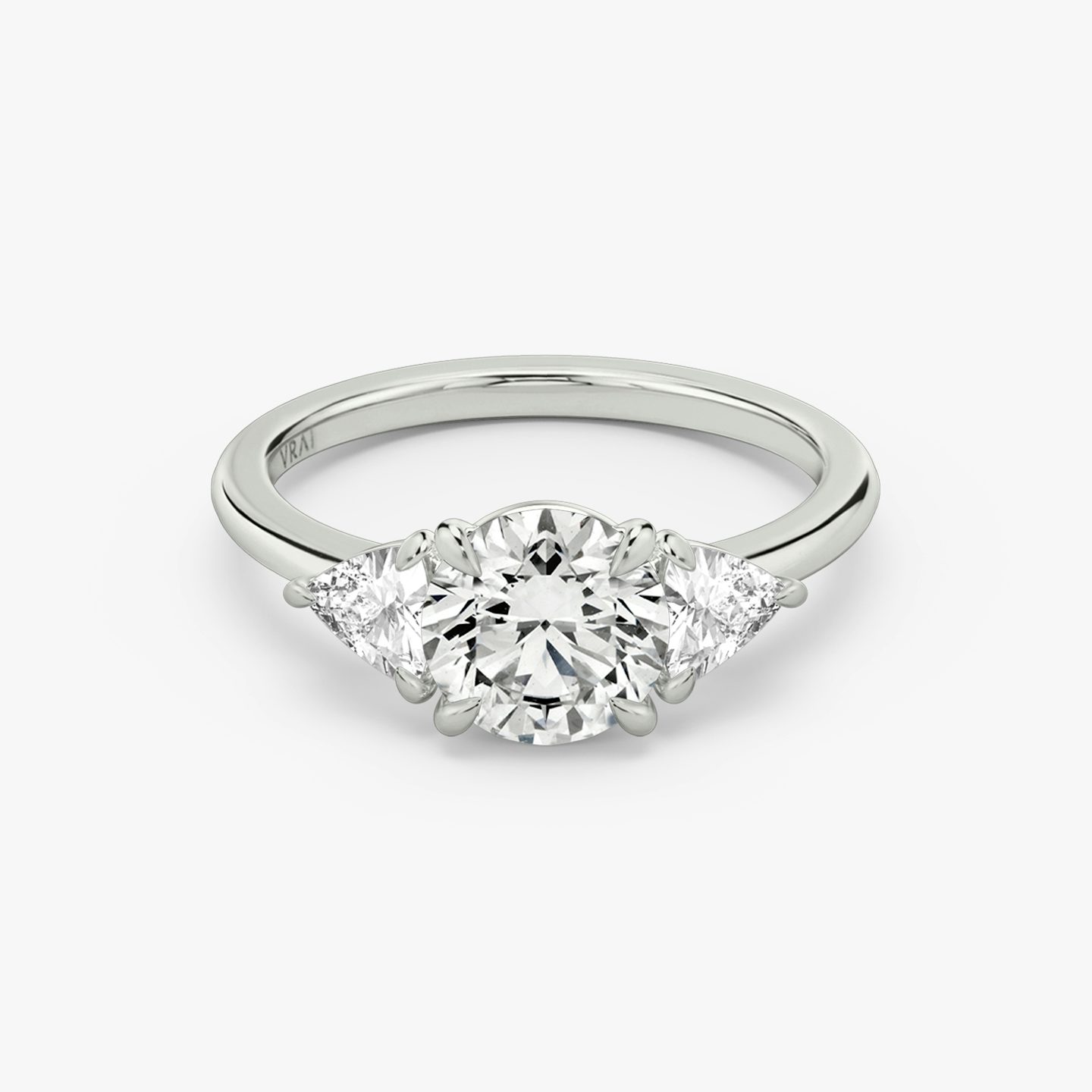 The Three Stone | Round Brilliant | Platinum | bandAccent: Plain | caratWeight: other | sideStoneCarat: 0.25ct | sideStoneShape: Trillion | diamondOrientation: vertical