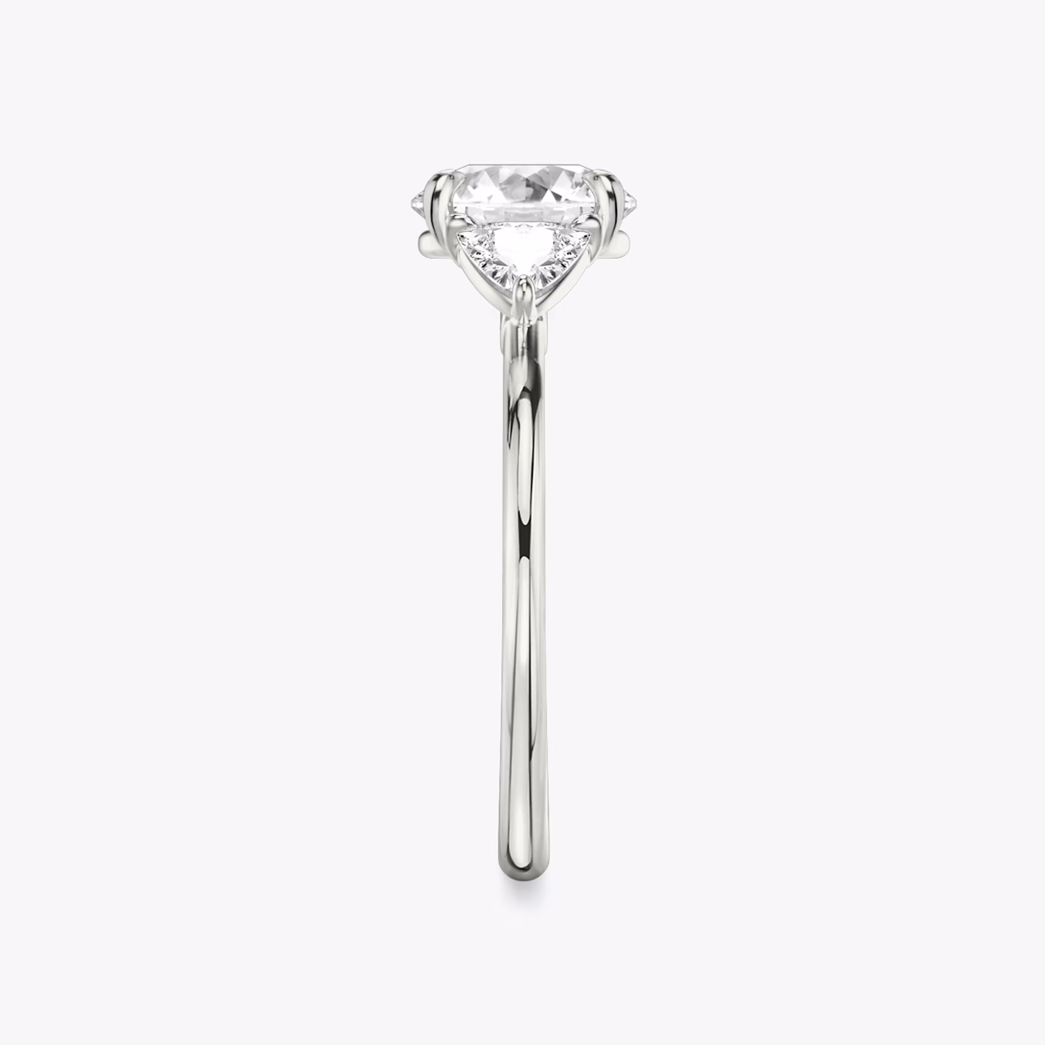 The Three Stone | Round Brilliant | Platinum | bandAccent: Plain | caratWeight: other | sideStoneCarat: 0.25ct | sideStoneShape: Trillion | diamondOrientation: vertical