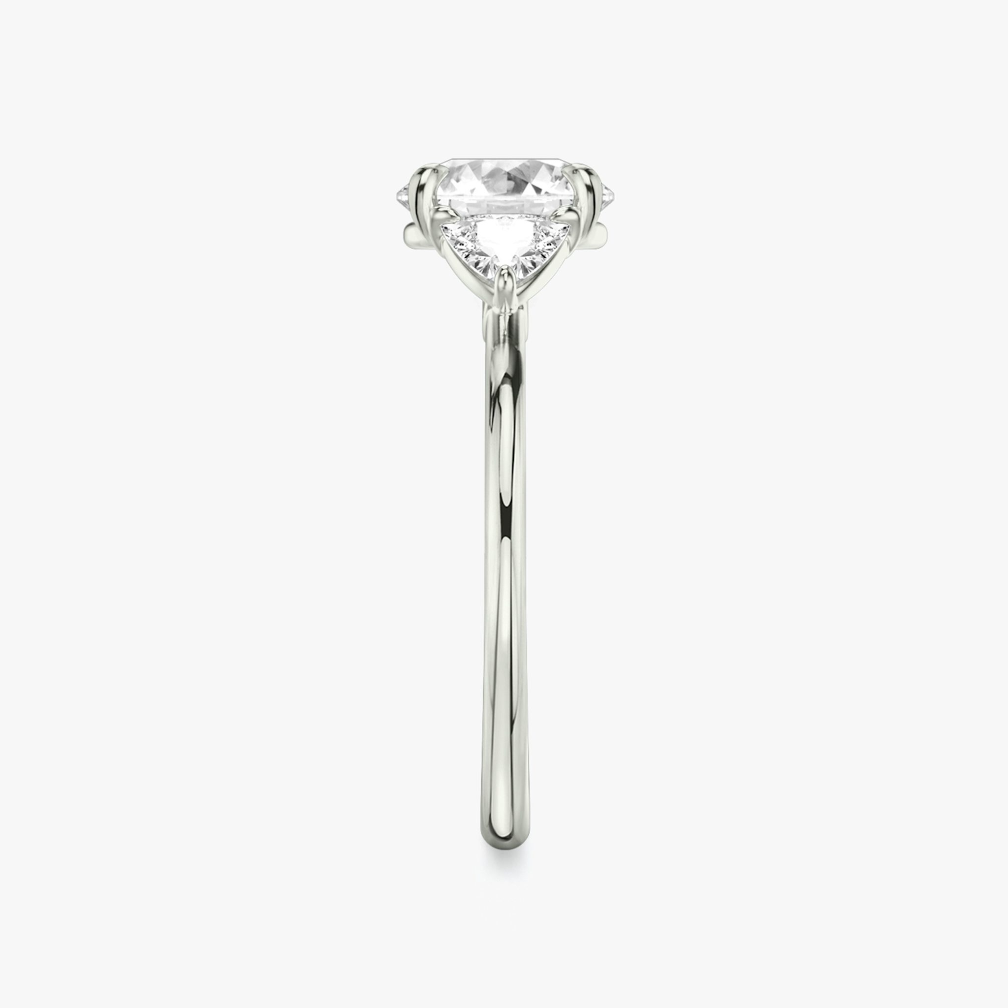 The Three Stone | Round Brilliant | Platinum | bandAccent: Plain | caratWeight: other | sideStoneCarat: 0.25ct | sideStoneShape: Trillion | diamondOrientation: vertical