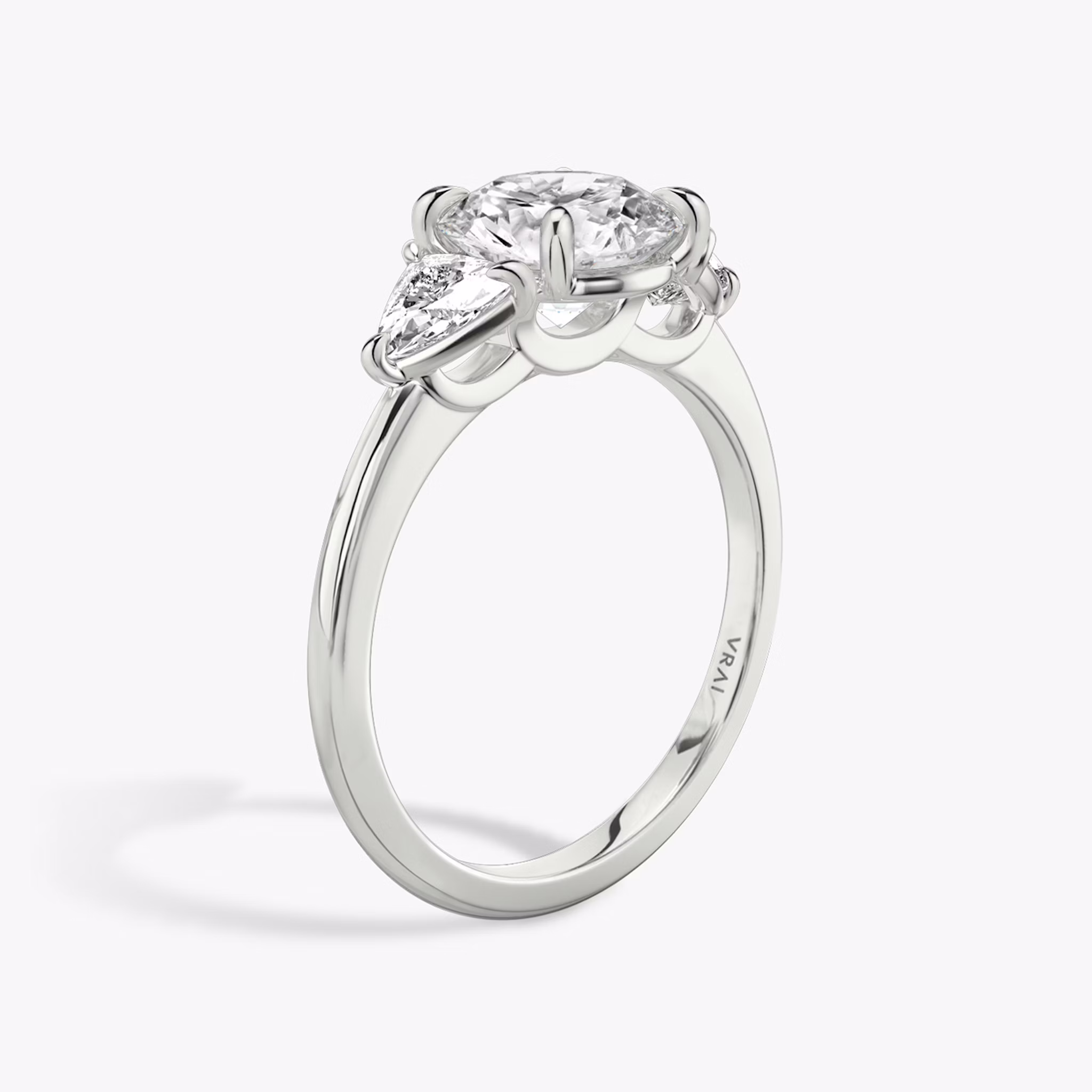 The Three Stone | Round Brilliant | Platinum | bandAccent: Plain | caratWeight: other | sideStoneCarat: 0.25ct | sideStoneShape: Trillion | diamondOrientation: vertical