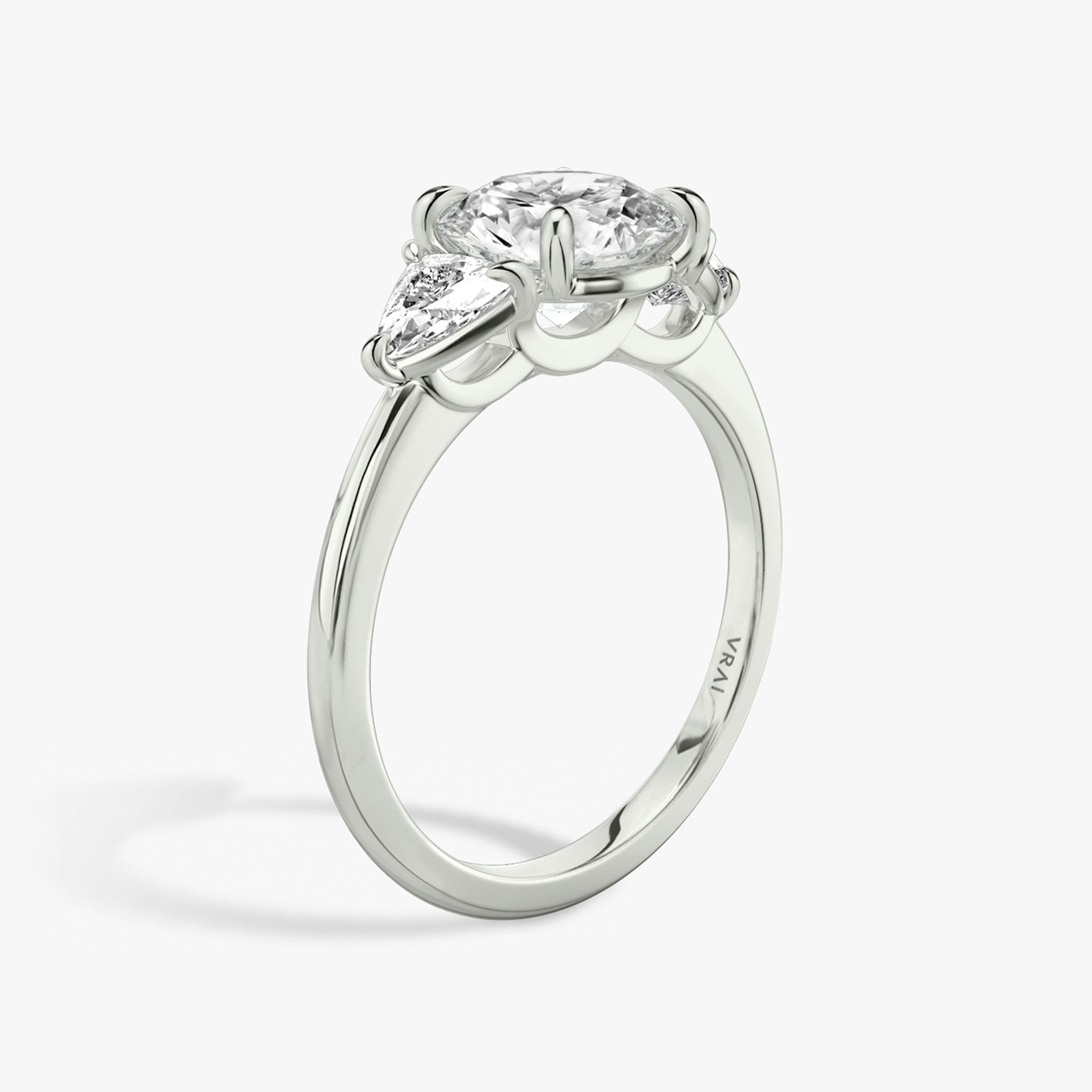 The Three Stone | Round Brilliant | Platinum | bandAccent: Plain | caratWeight: other | sideStoneCarat: 0.25ct | sideStoneShape: Trillion | diamondOrientation: vertical