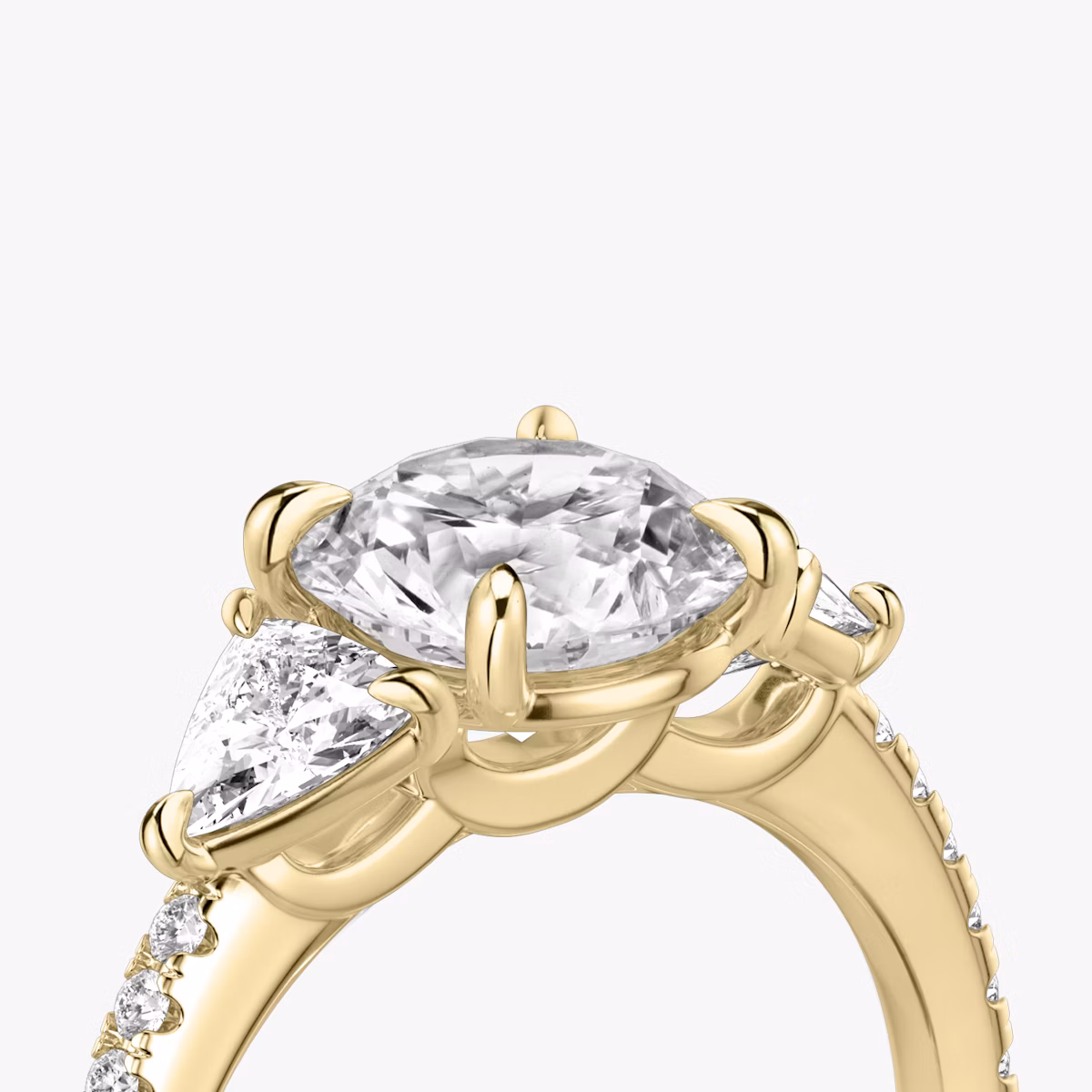 The Three Stone | Round Brilliant | 18k | Yellow Gold | bandAccent: Pavé | caratWeight: other | sideStoneCarat: 0.25ct | sideStoneShape: Trillion | diamondOrientation: vertical