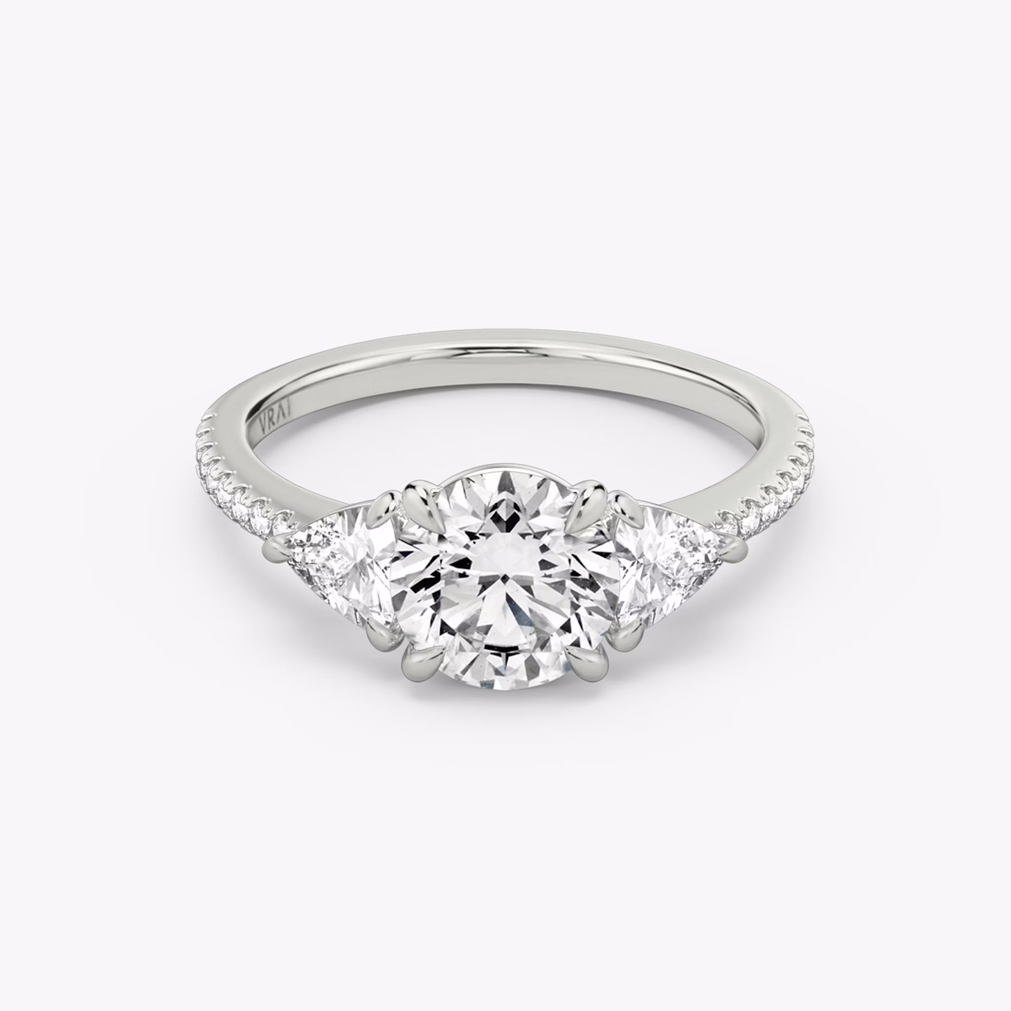 The Three Stone | Round Brilliant | 18k | White Gold | bandAccent: Pavé | caratWeight: other | sideStoneCarat: 0.25ct | sideStoneShape: Trillion | diamondOrientation: vertical