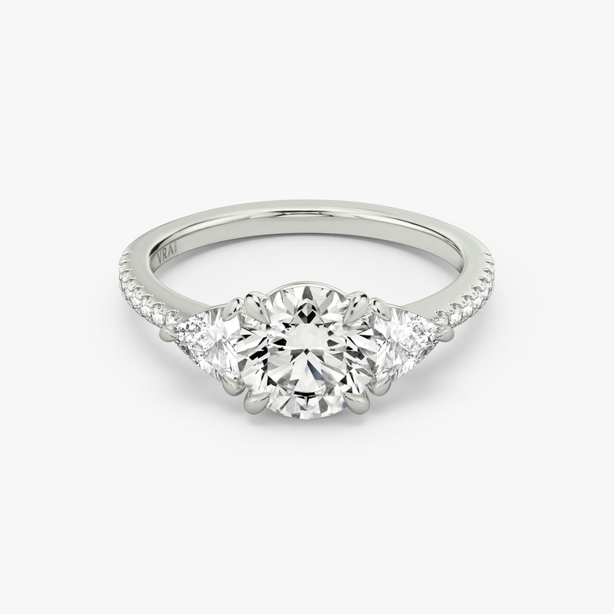 The Three Stone | Round Brilliant | 18k | White Gold | bandAccent: Pavé | caratWeight: other | sideStoneCarat: 0.25ct | sideStoneShape: Trillion | diamondOrientation: vertical