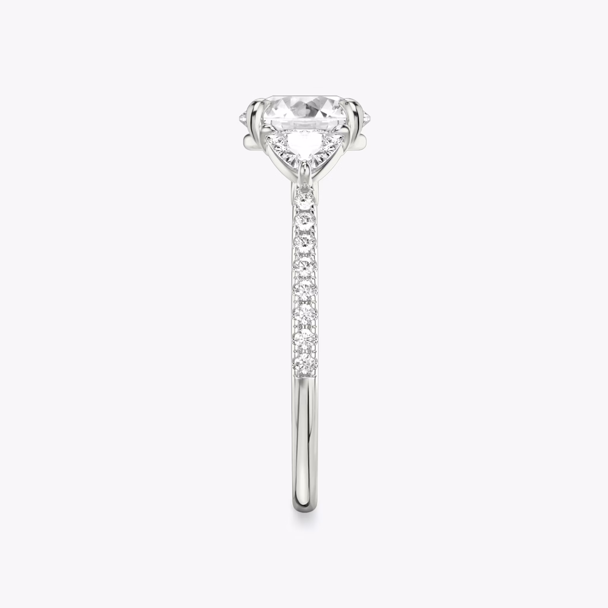 The Three Stone | Round Brilliant | 18k | White Gold | bandAccent: Pavé | caratWeight: other | sideStoneCarat: 0.25ct | sideStoneShape: Trillion | diamondOrientation: vertical