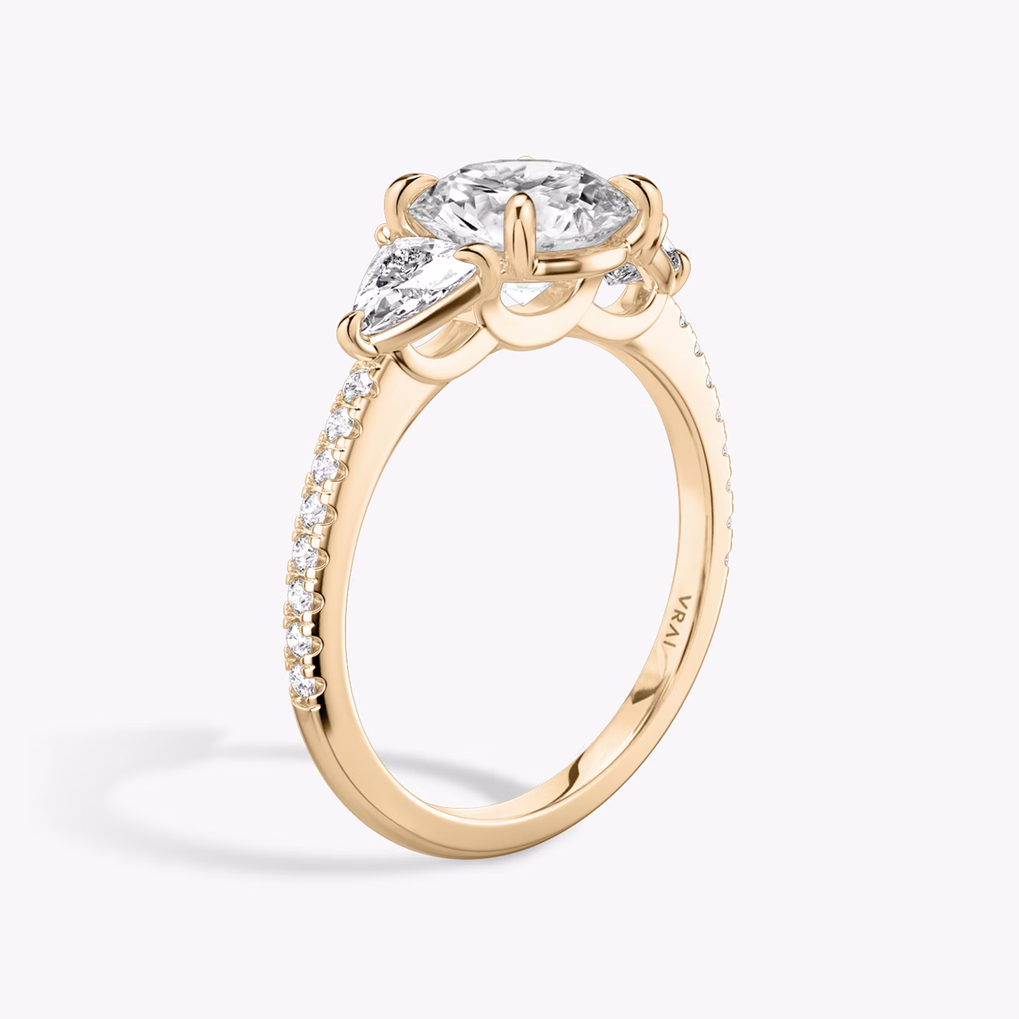 The Three Stone | Round Brilliant | 14k | Rose Gold | bandAccent: Pavé | caratWeight: other | sideStoneCarat: 0.25ct | sideStoneShape: Trillion | diamondOrientation: vertical