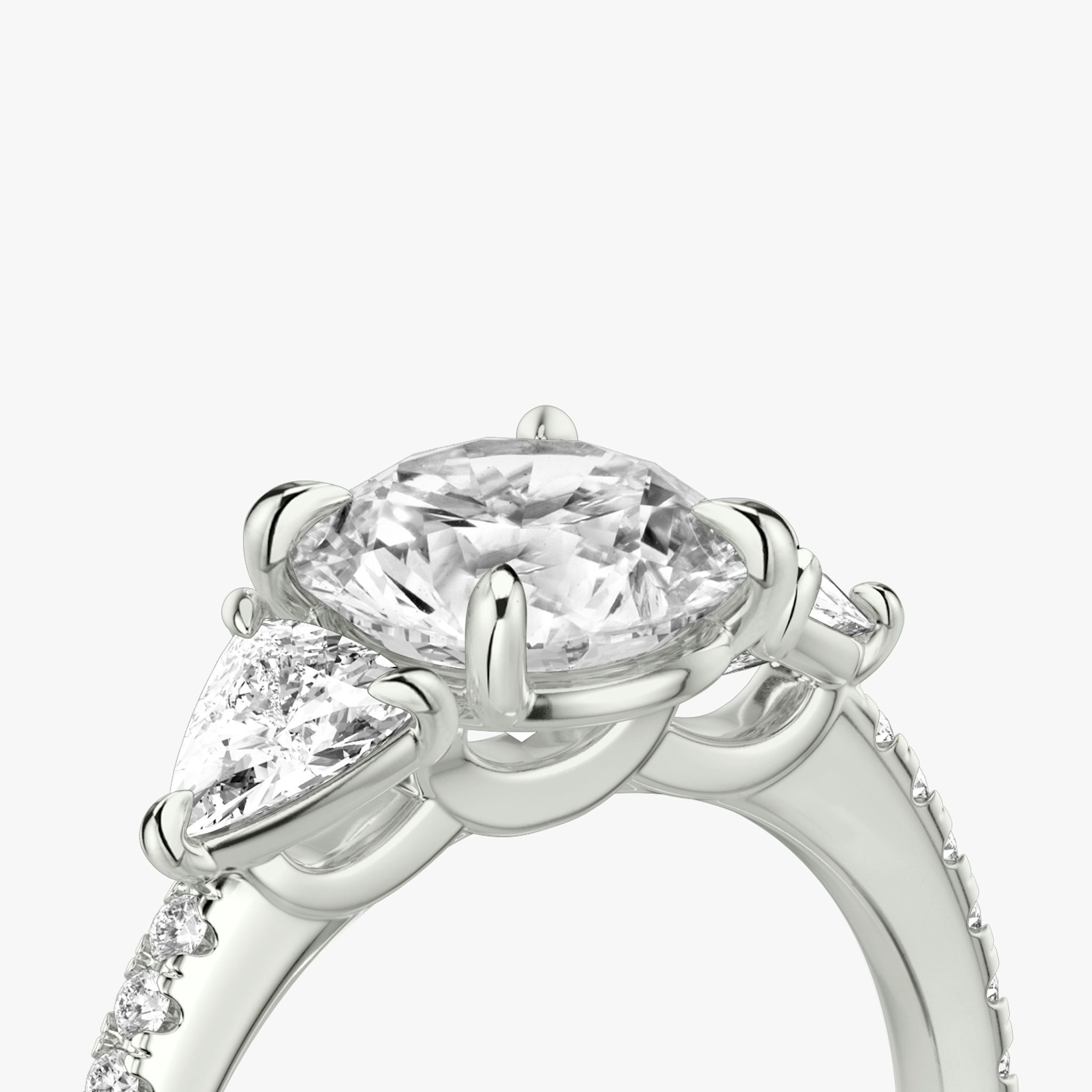 The Three Stone | Round Brilliant | Platinum | bandAccent: Pavé | caratWeight: other | sideStoneCarat: 0.25ct | sideStoneShape: Trillion | diamondOrientation: vertical