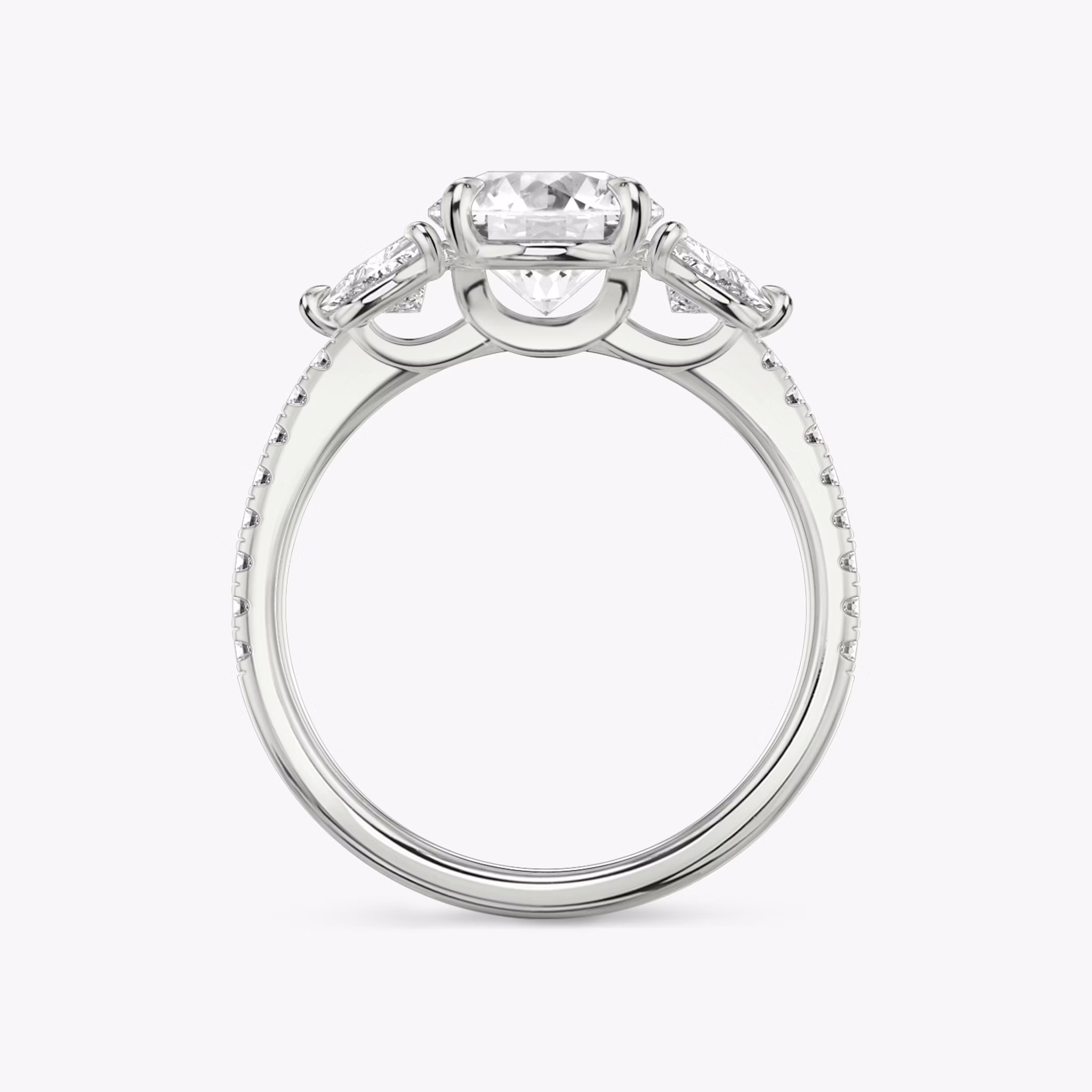The Three Stone | Round Brilliant | Platinum | bandAccent: Pavé | caratWeight: other | sideStoneCarat: 0.25ct | sideStoneShape: Trillion | diamondOrientation: vertical