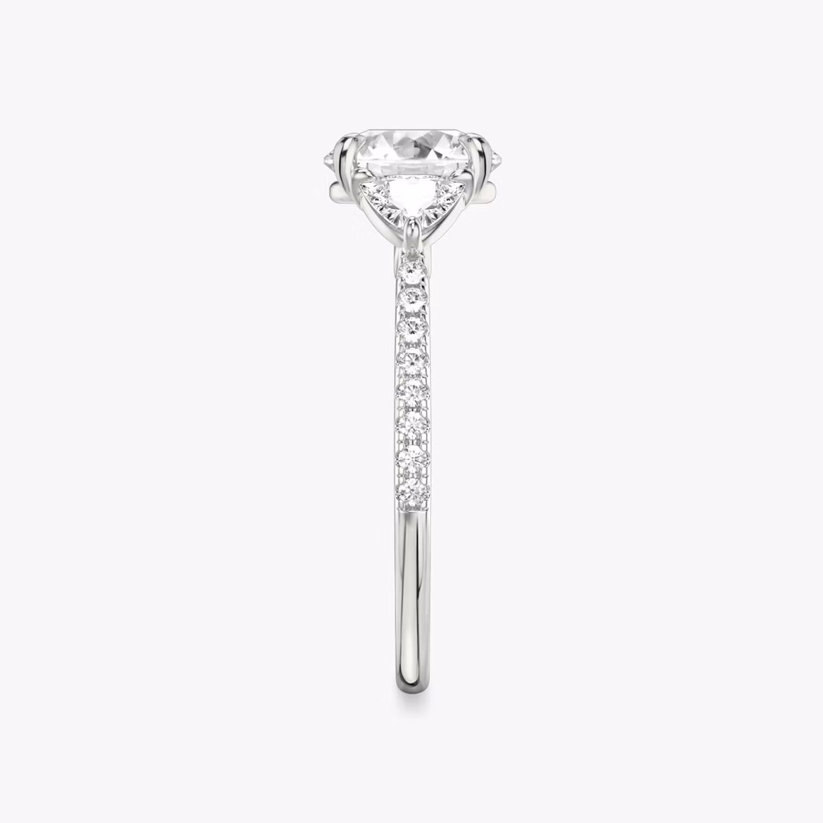 The Three Stone | Round Brilliant | Platinum | bandAccent: Pavé | caratWeight: other | sideStoneCarat: 0.25ct | sideStoneShape: Trillion | diamondOrientation: vertical