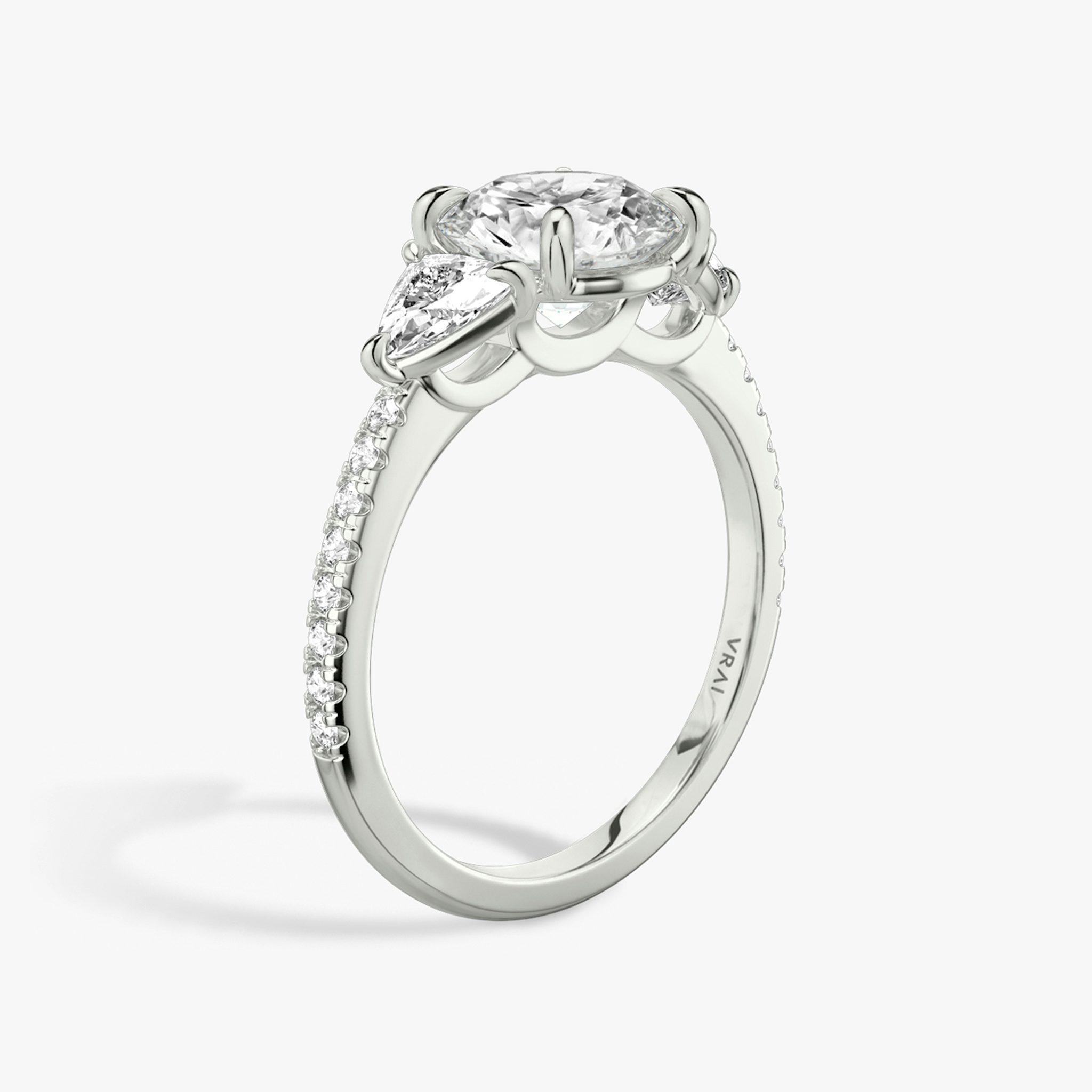 The Three Stone | Round Brilliant | Platinum | bandAccent: Pavé | caratWeight: other | sideStoneCarat: 0.25ct | sideStoneShape: Trillion | diamondOrientation: vertical