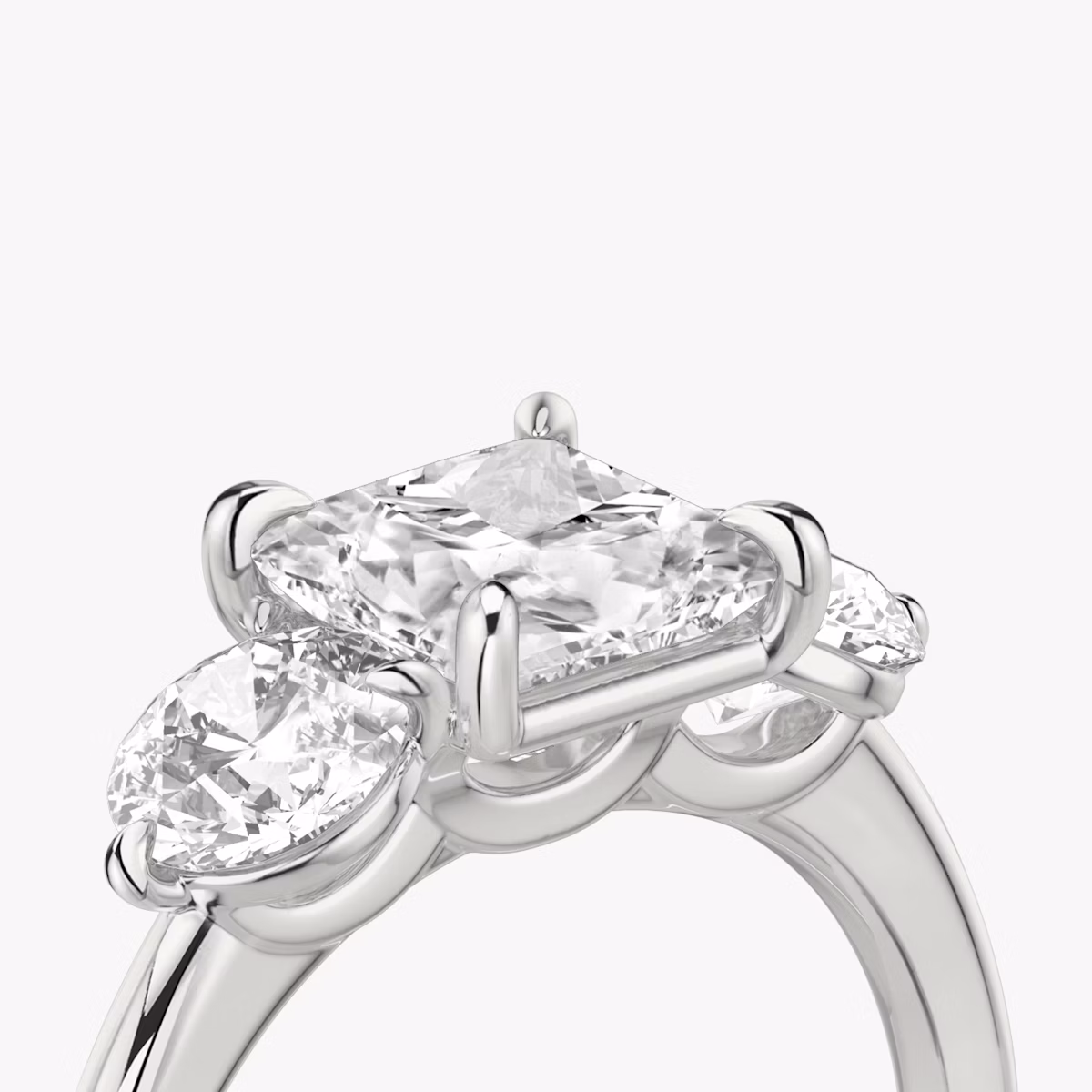 The Three Stone | Princess | Platinum | bandAccent: Plain | sideStoneCarat: 0.50ct | sideStoneShape: Round Brilliant | diamondOrientation: vertical | caratWeight: other