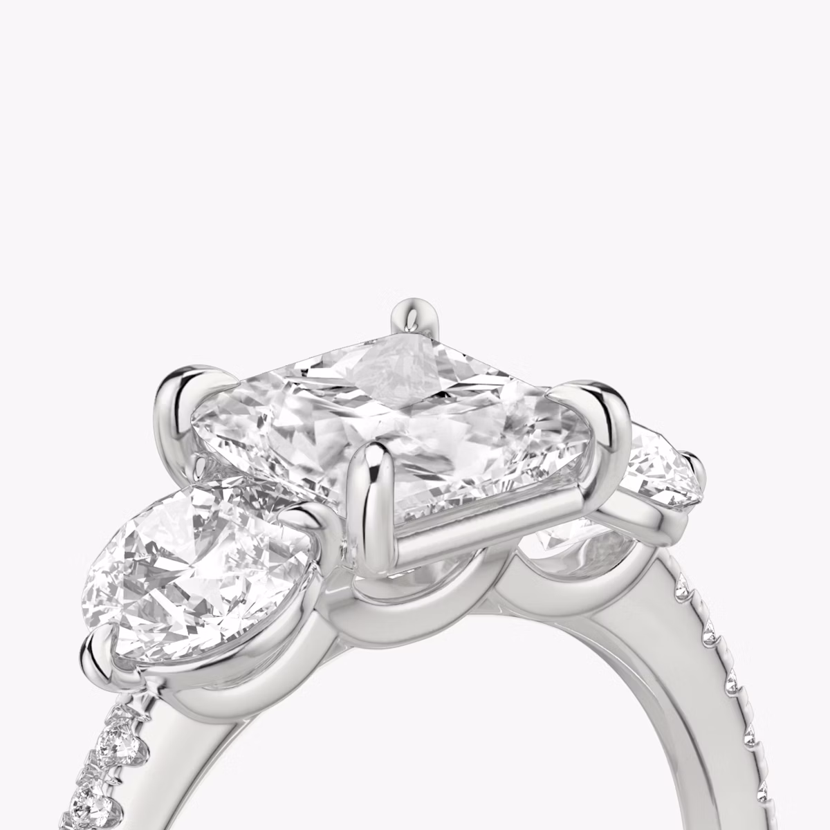 The Three Stone | Princess | Platinum | bandAccent: Pavé | sideStoneCarat: 0.50ct | sideStoneShape: Round Brilliant | diamondOrientation: vertical | caratWeight: other