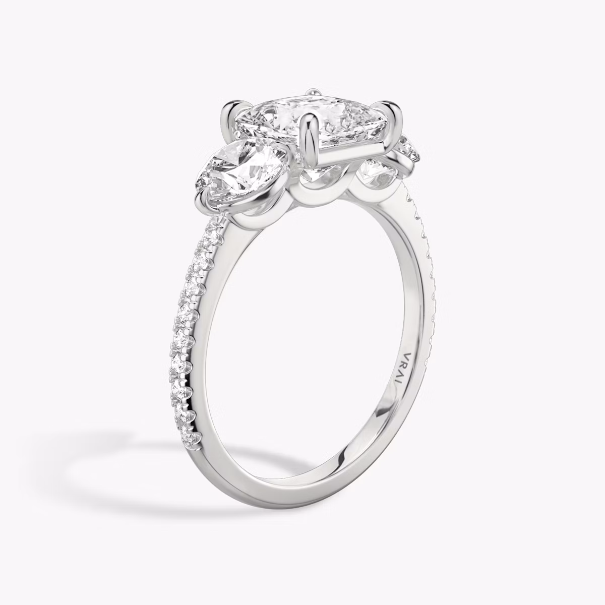 The Three Stone | Princess | Platinum | bandAccent: Pavé | sideStoneCarat: 0.50ct | sideStoneShape: Round Brilliant | diamondOrientation: vertical | caratWeight: other
