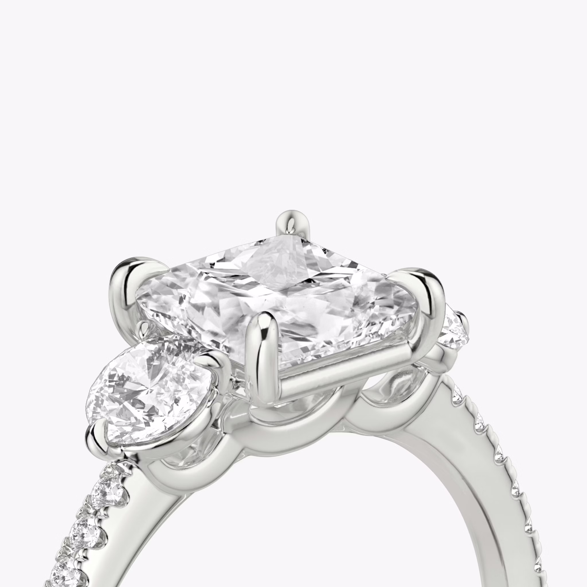 The Three Stone | Princess | 18k | White Gold | bandAccent: Pavé | sideStoneCarat: 0.25ct | sideStoneShape: Round Brilliant | diamondOrientation: vertical | caratWeight: other