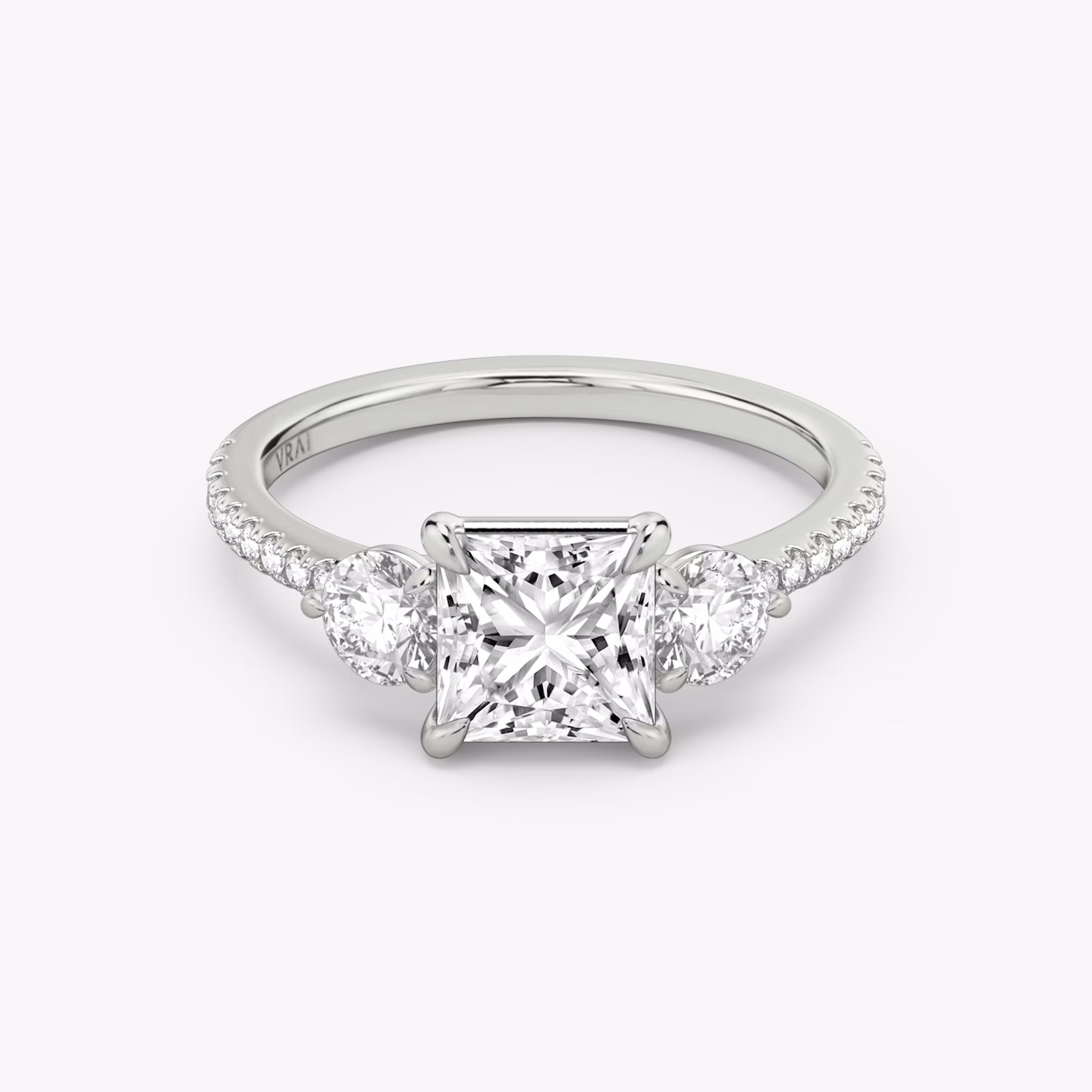 The Three Stone | Princess | 18k | White Gold | bandAccent: Pavé | sideStoneCarat: 0.25ct | sideStoneShape: Round Brilliant | diamondOrientation: vertical | caratWeight: other
