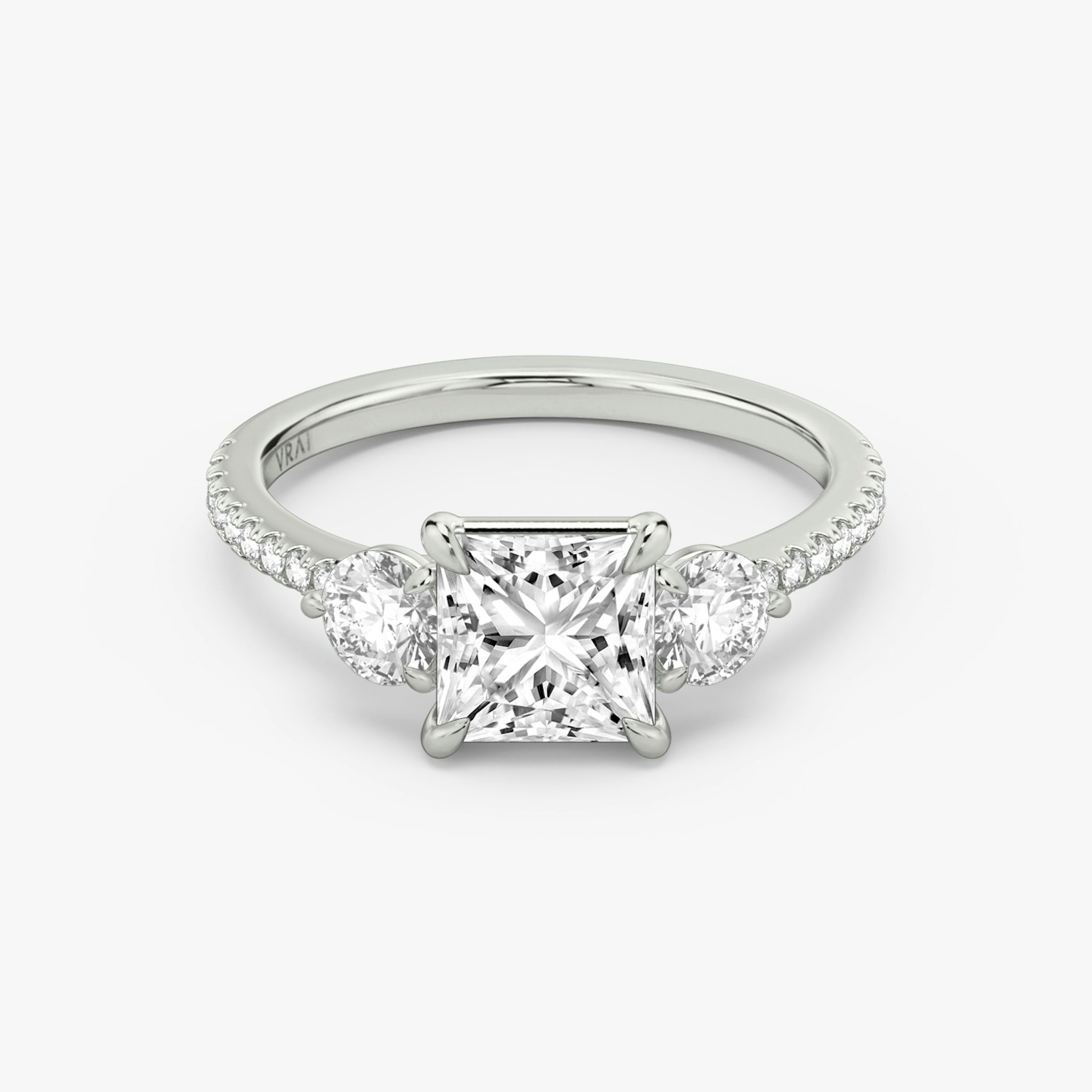 The Three Stone | Princess | 18k | White Gold | bandAccent: Pavé | sideStoneCarat: 0.25ct | sideStoneShape: Round Brilliant | diamondOrientation: vertical | caratWeight: other