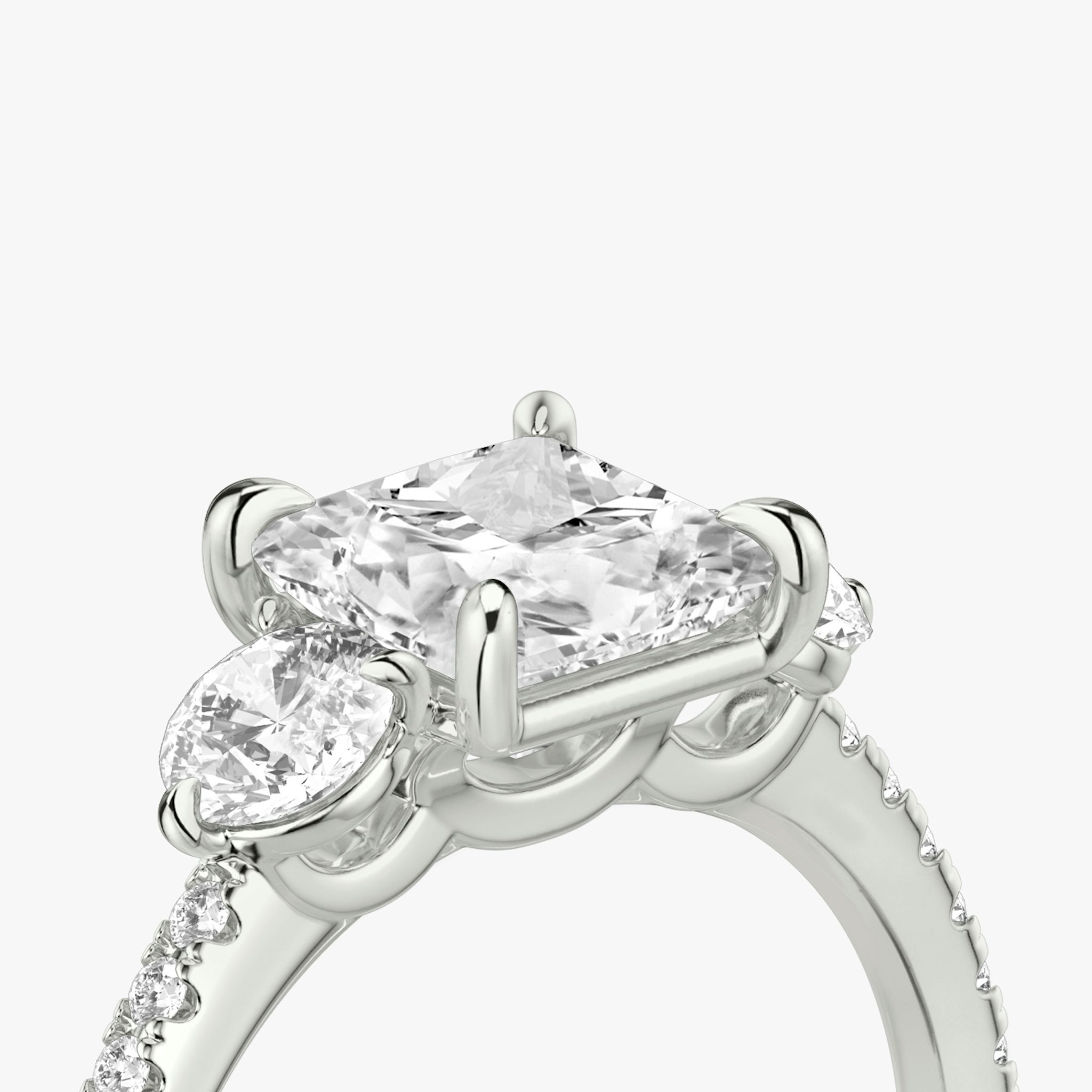 The Three Stone | Princess | Platinum | bandAccent: Pavé | sideStoneCarat: 0.25ct | sideStoneShape: Round Brilliant | diamondOrientation: vertical | caratWeight: other