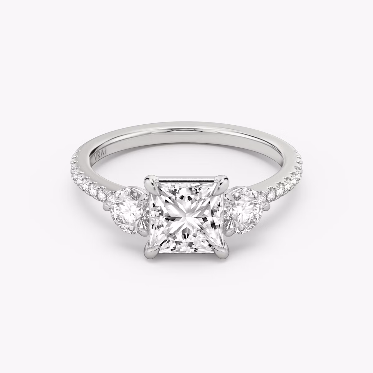 The Three Stone | Princess | Platinum | bandAccent: Pavé | sideStoneCarat: 0.25ct | sideStoneShape: Round Brilliant | diamondOrientation: vertical | caratWeight: other
