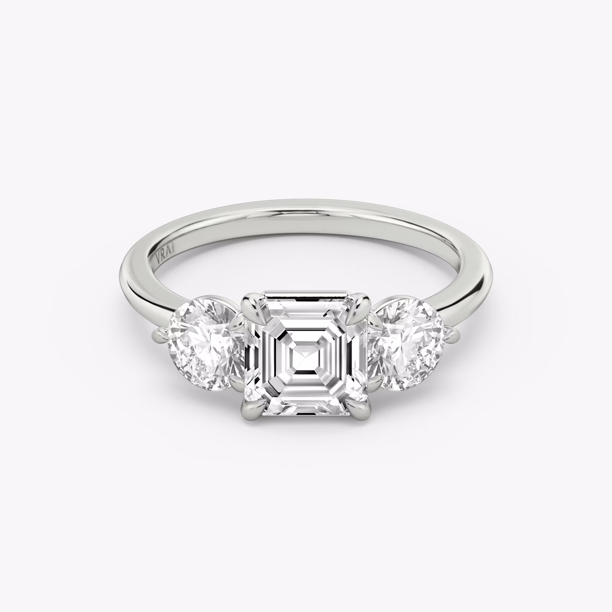 The Three Stone | Asscher | 18k | White Gold | bandAccent: Plain | sideStoneCarat: 0.50ct | sideStoneShape: Round Brilliant | diamondOrientation: vertical | caratWeight: other