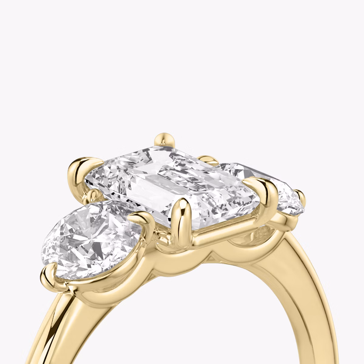 The Three Stone | Emerald | 18k | Yellow Gold | bandAccent: Plain | sideStoneCarat: 0.50ct | sideStoneShape: Round Brilliant | diamondOrientation: vertical | caratWeight: other